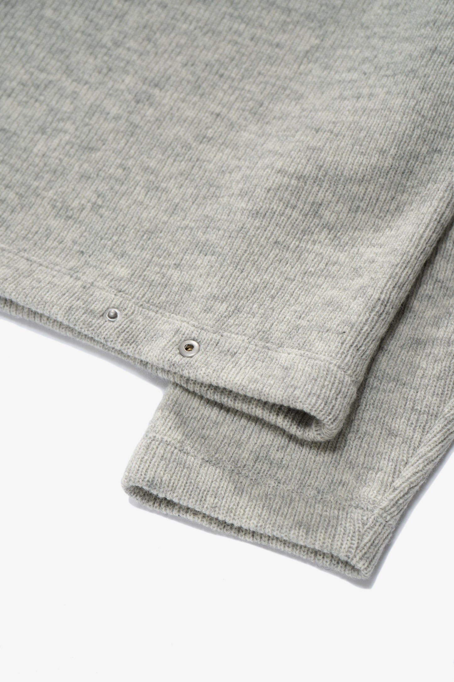 Close-up of rear waist of LW770CW V Neck Snap Sweater, showing snaps