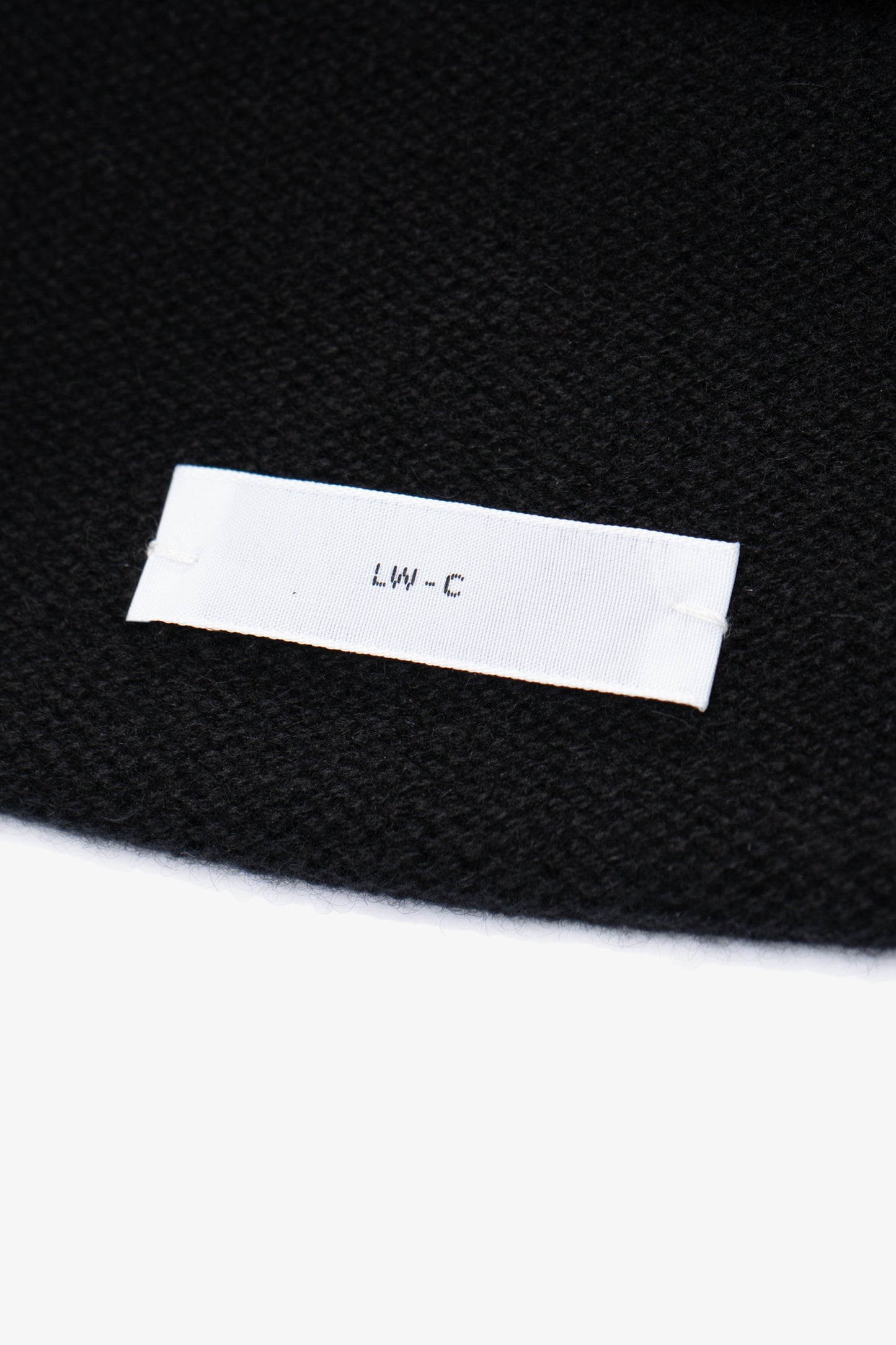 Close-up of fabric and tag of LW036 Ambrosia Beanie in black