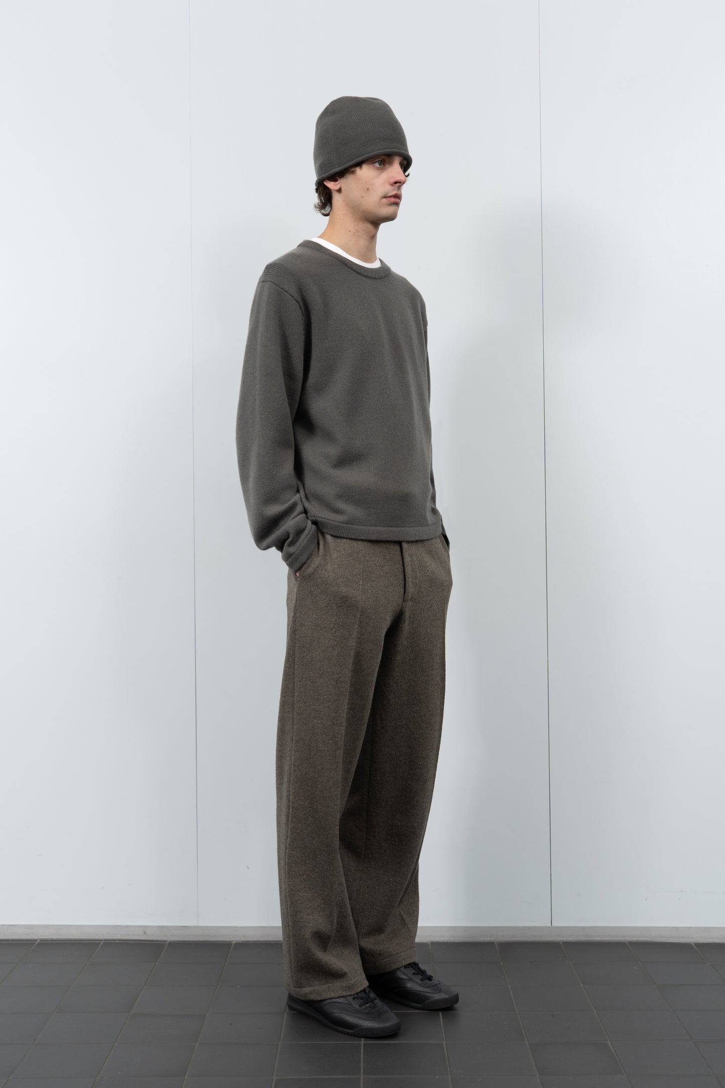 Full-length model poses wearing LW036 Ambrosia beanie in marine gray