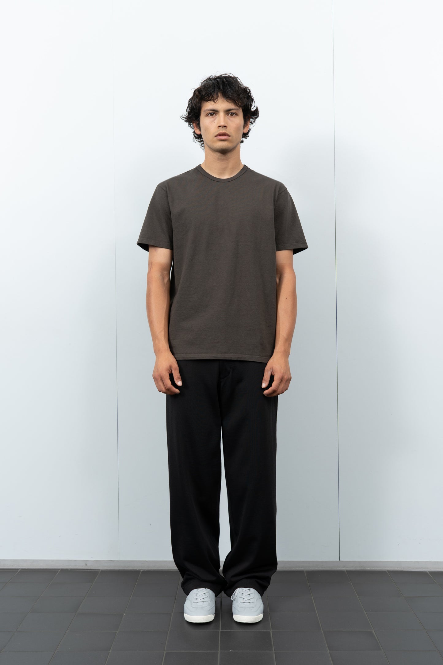 Front-facing on-model photograph of model wearing LW101 Our T-shirt in Black Pine