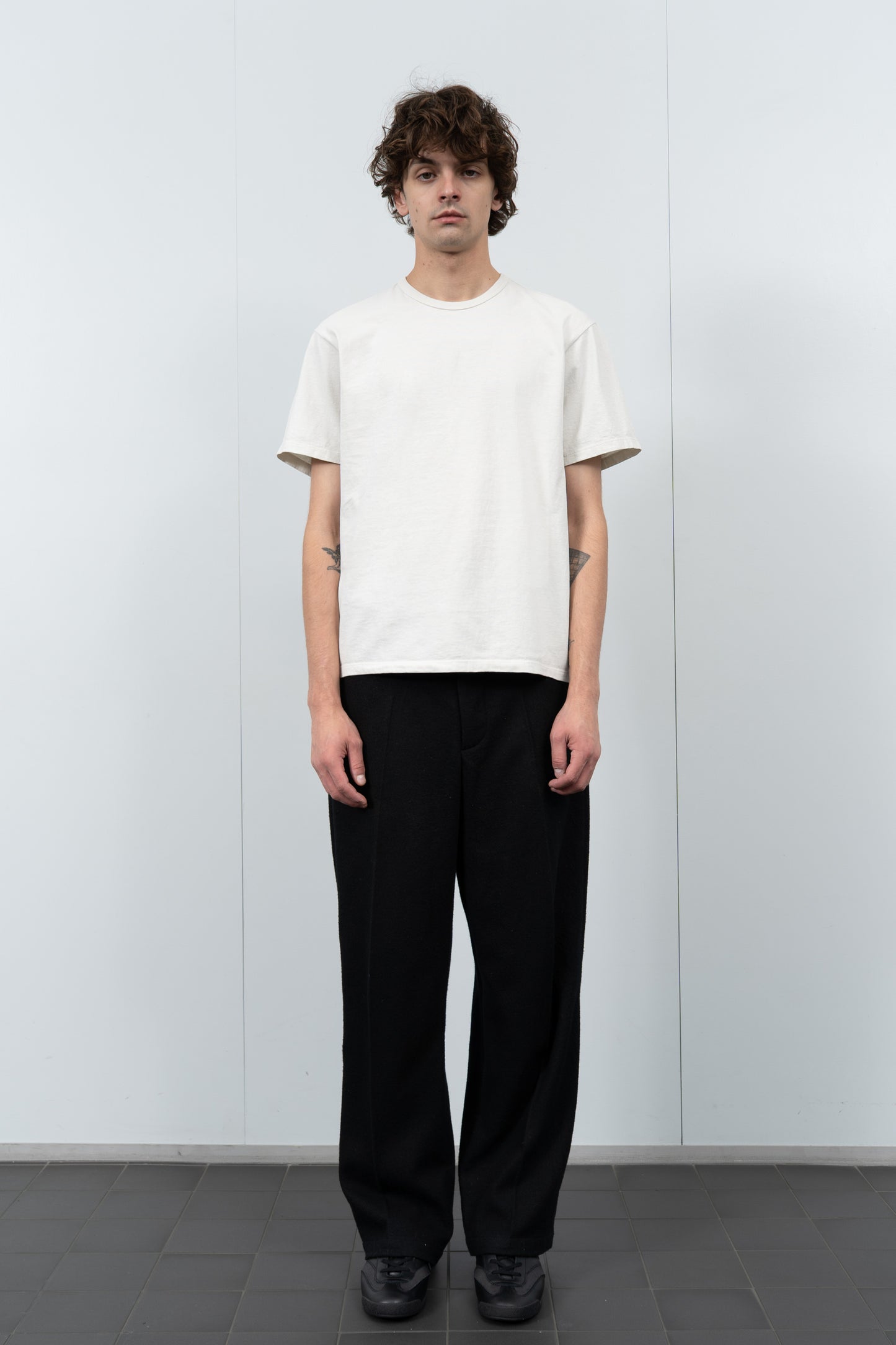 Model poses in LW101 Our T-shirt in off white