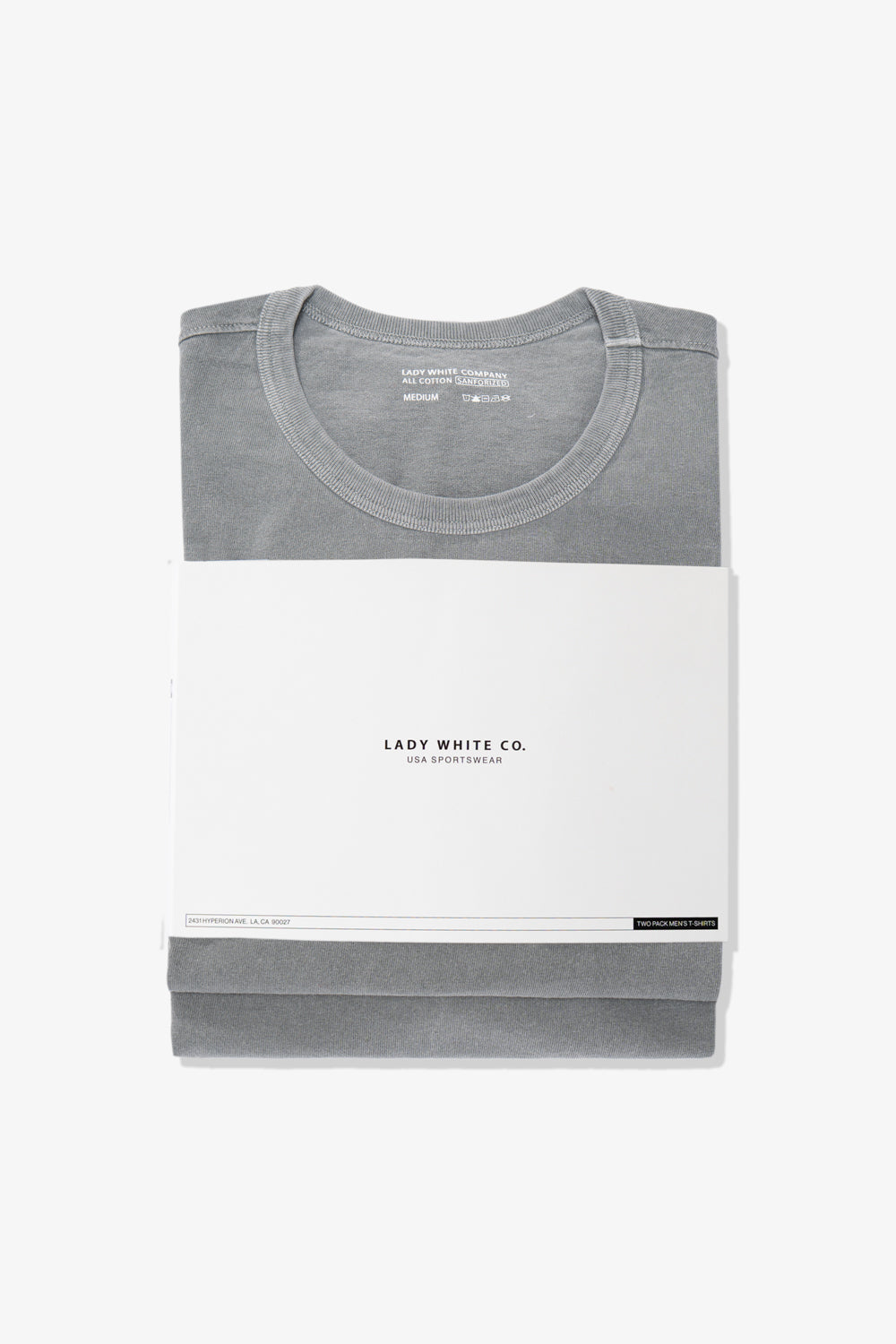 Two stacked LW101 Our T-shirts in pigment kelp encrosed in a belly band