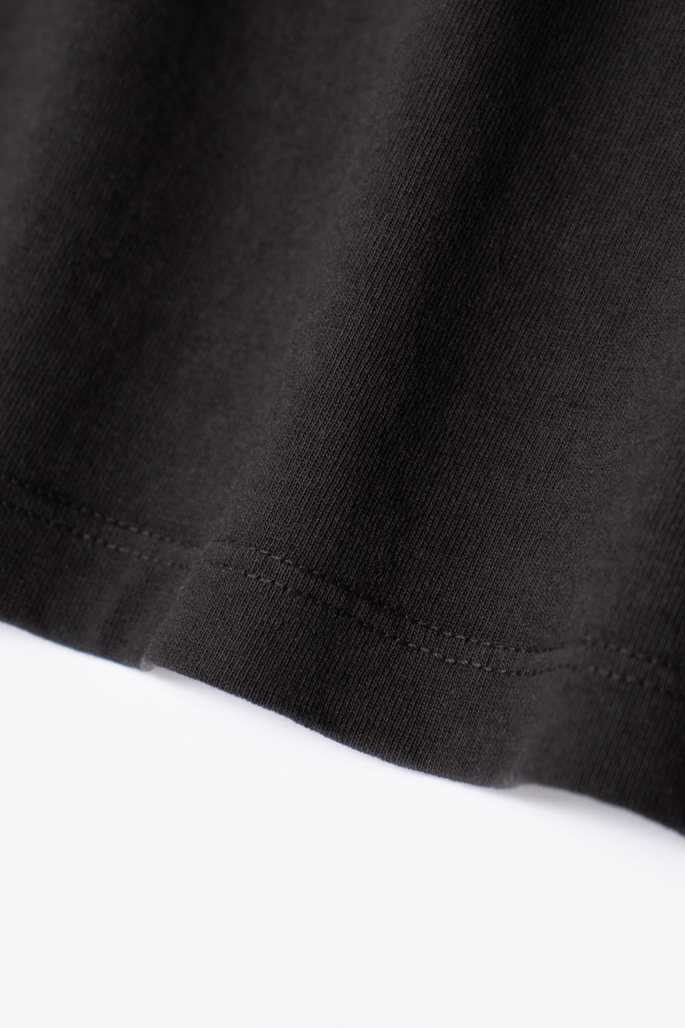 Two LW101 Our T-shirts stacked on top of each other, inside of a belly band