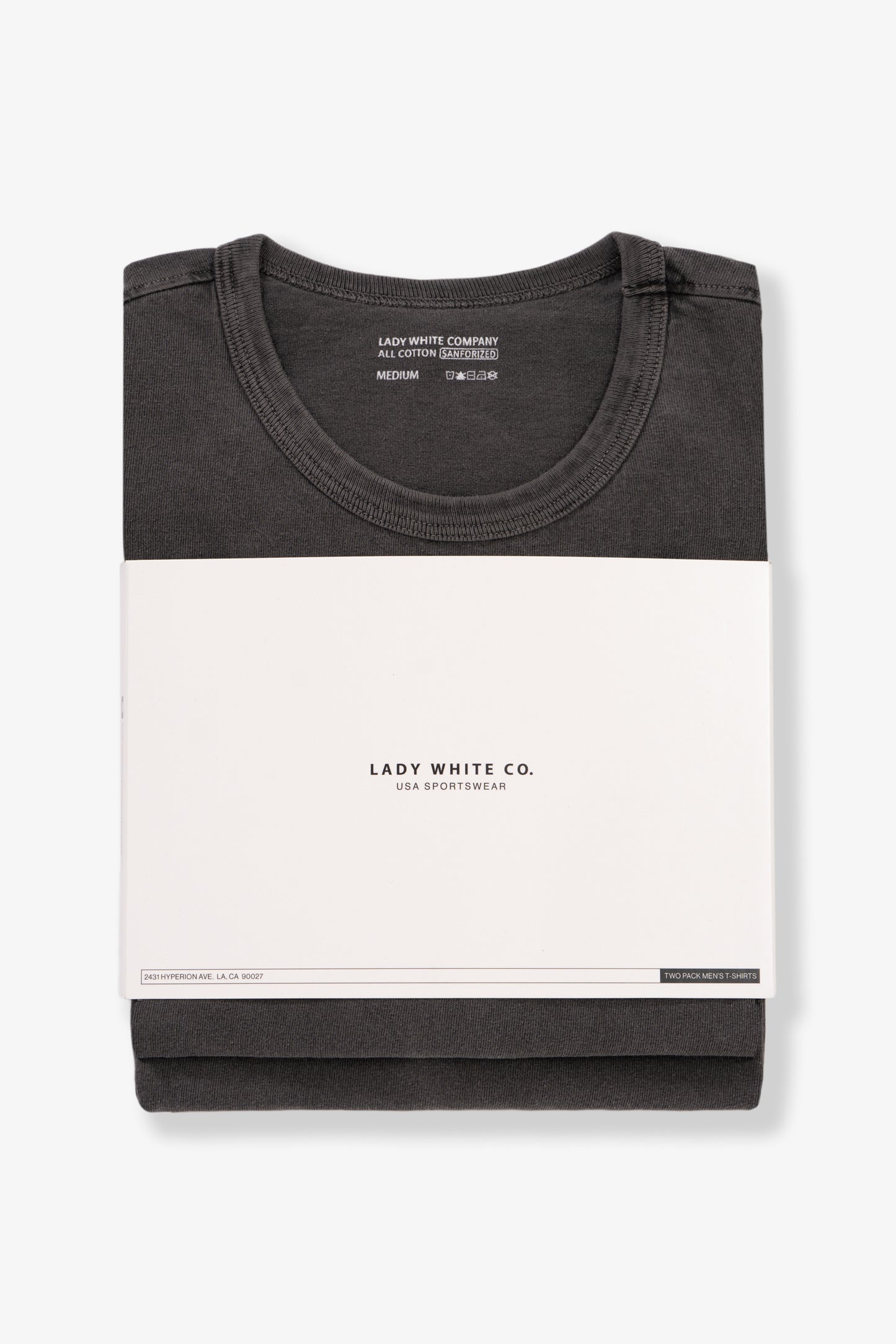 Two LW101 Our T-shirts, stacked on top of each other, enclosed in a belly band