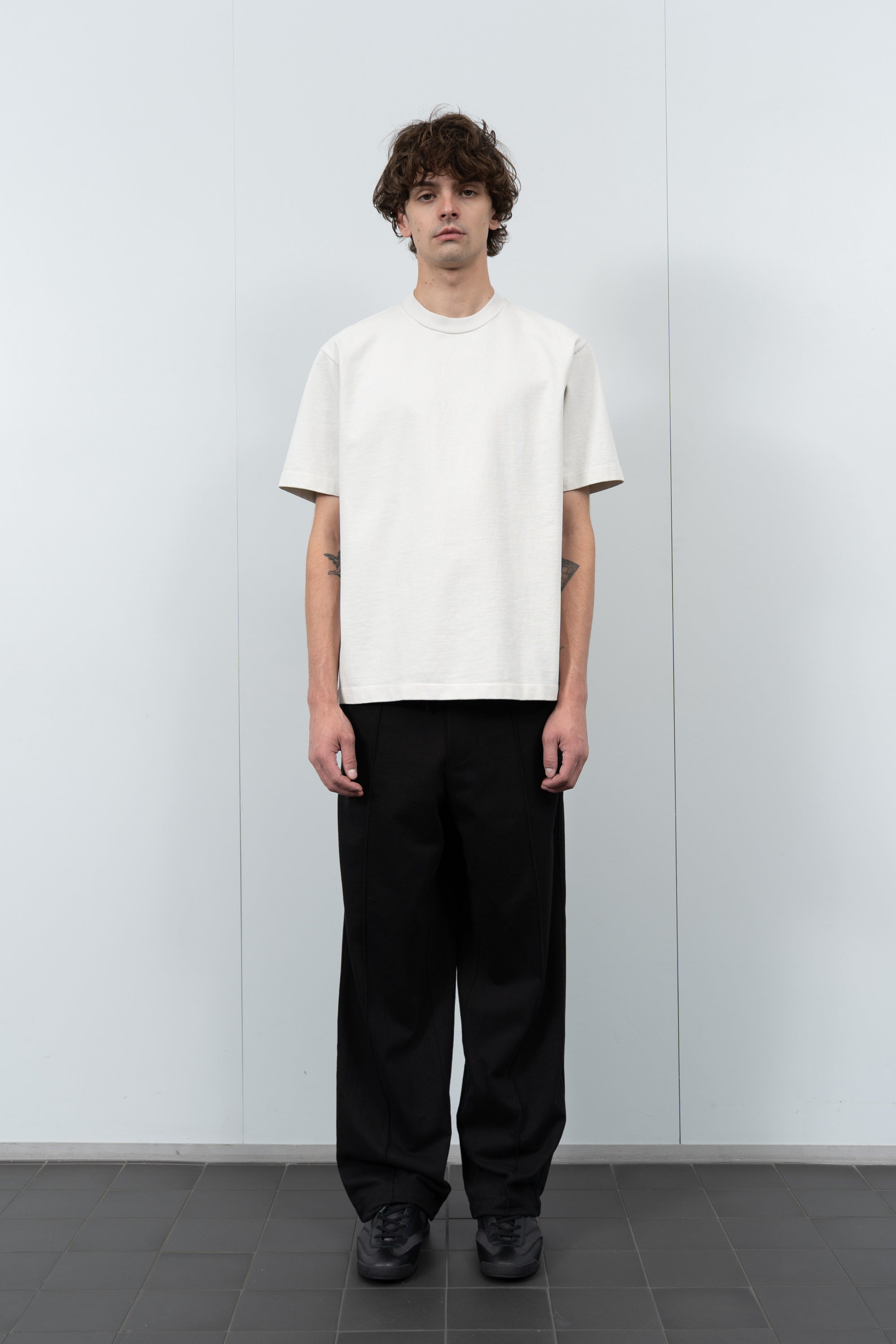 Model poses in LW130T Rugby T-shirt in off white