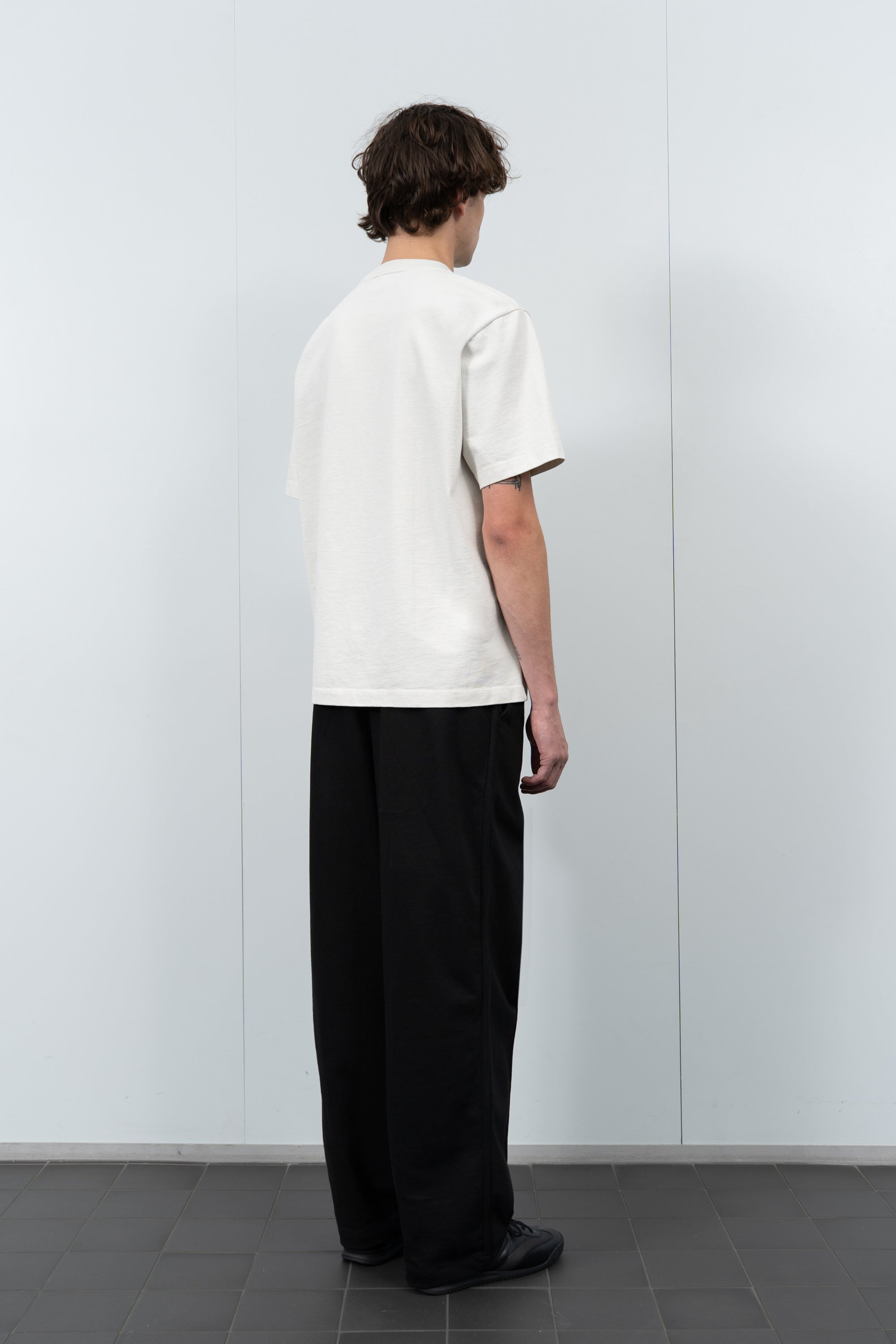 Model poses in LW130T Rugby T-shirt in off white