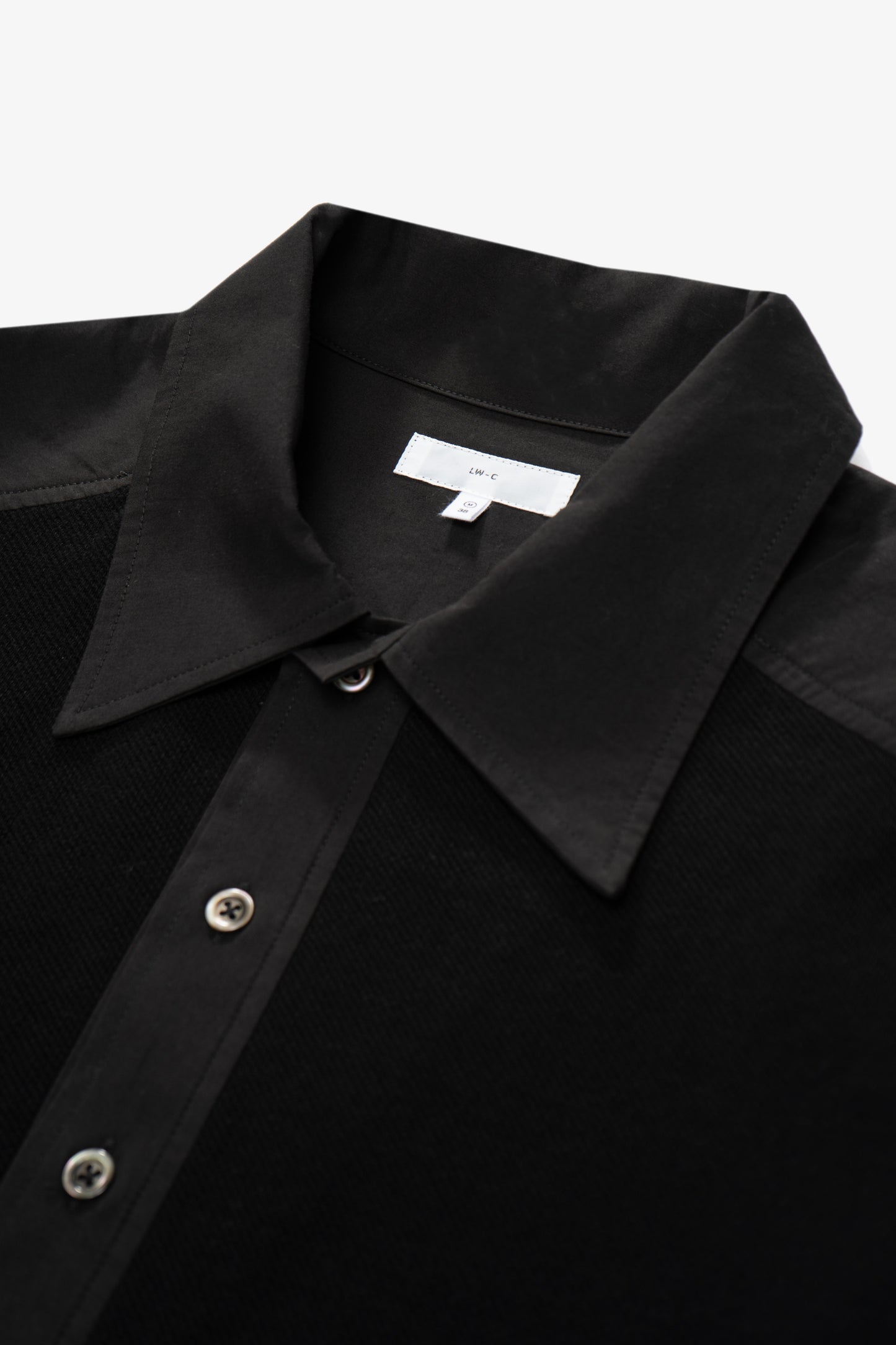 Collar detail of LW415CL Double Knit Polo in Black on a model