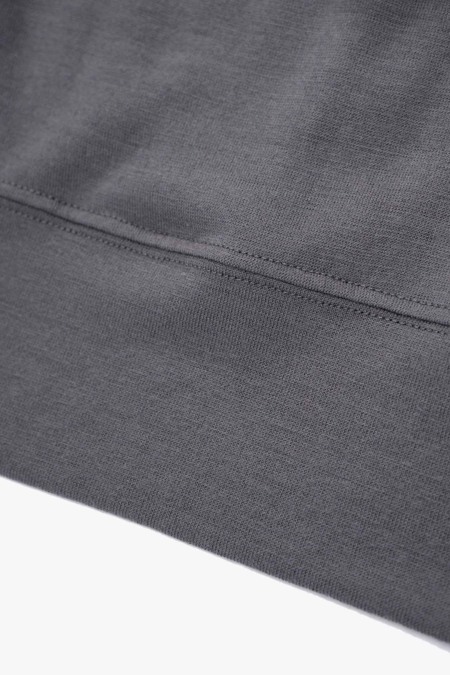 Close-up of waistband ribbing of LW601W Wool Jersey Sweater in slate grey