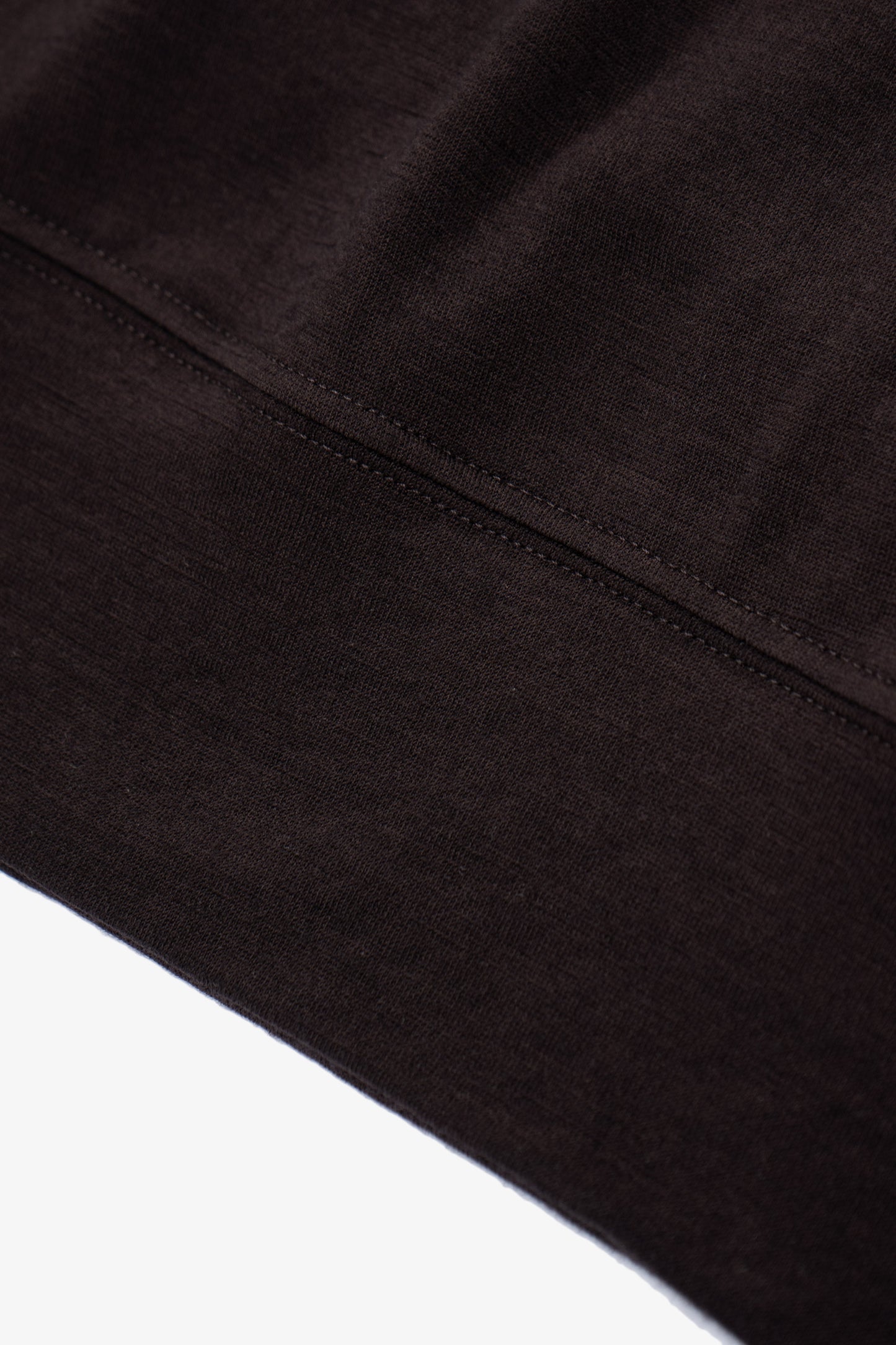 Close-up of waistband ribbing of LW601W Wool Jersey Sweater in woodberry