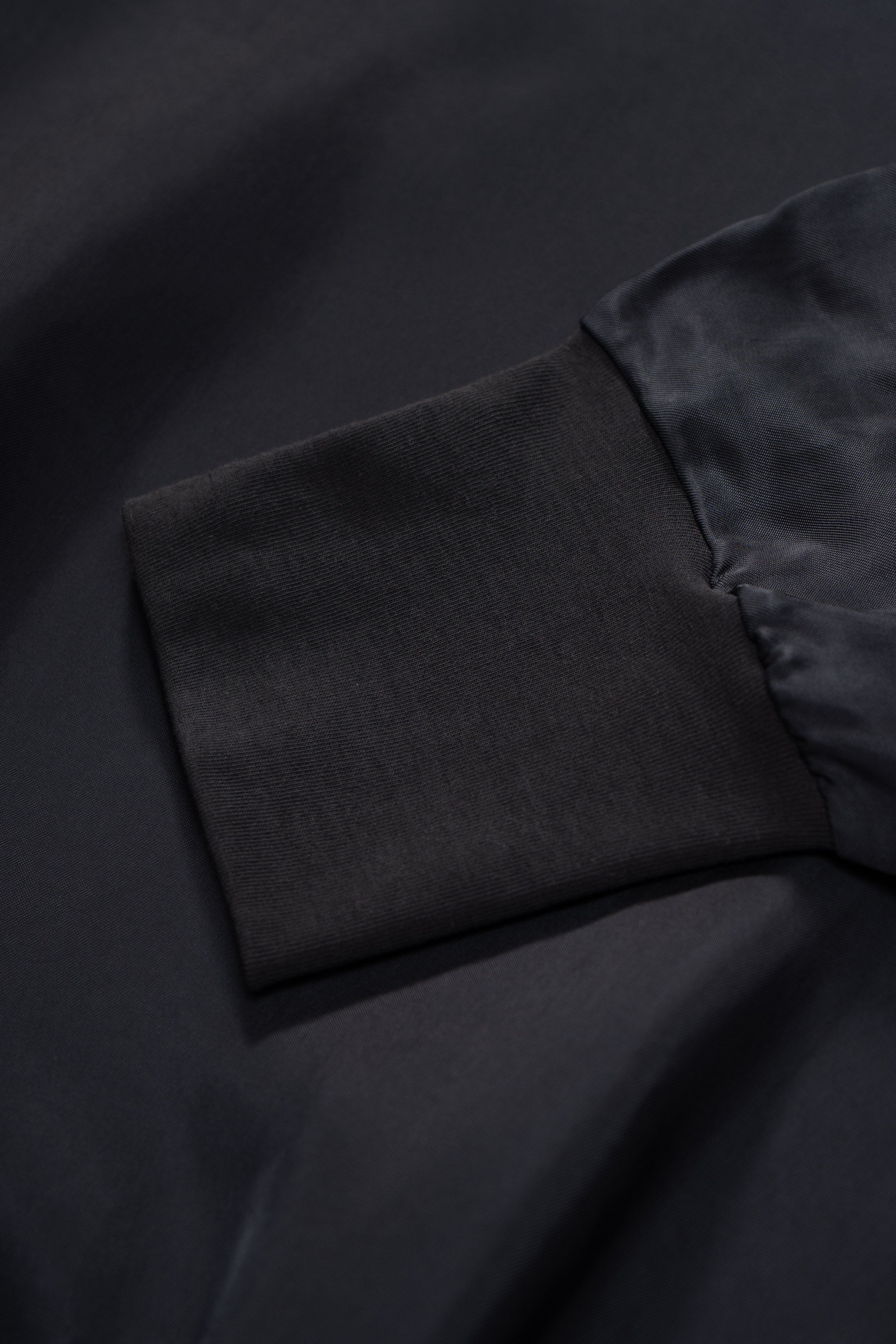Hem detail of LW605 Cupro Pullover in Black