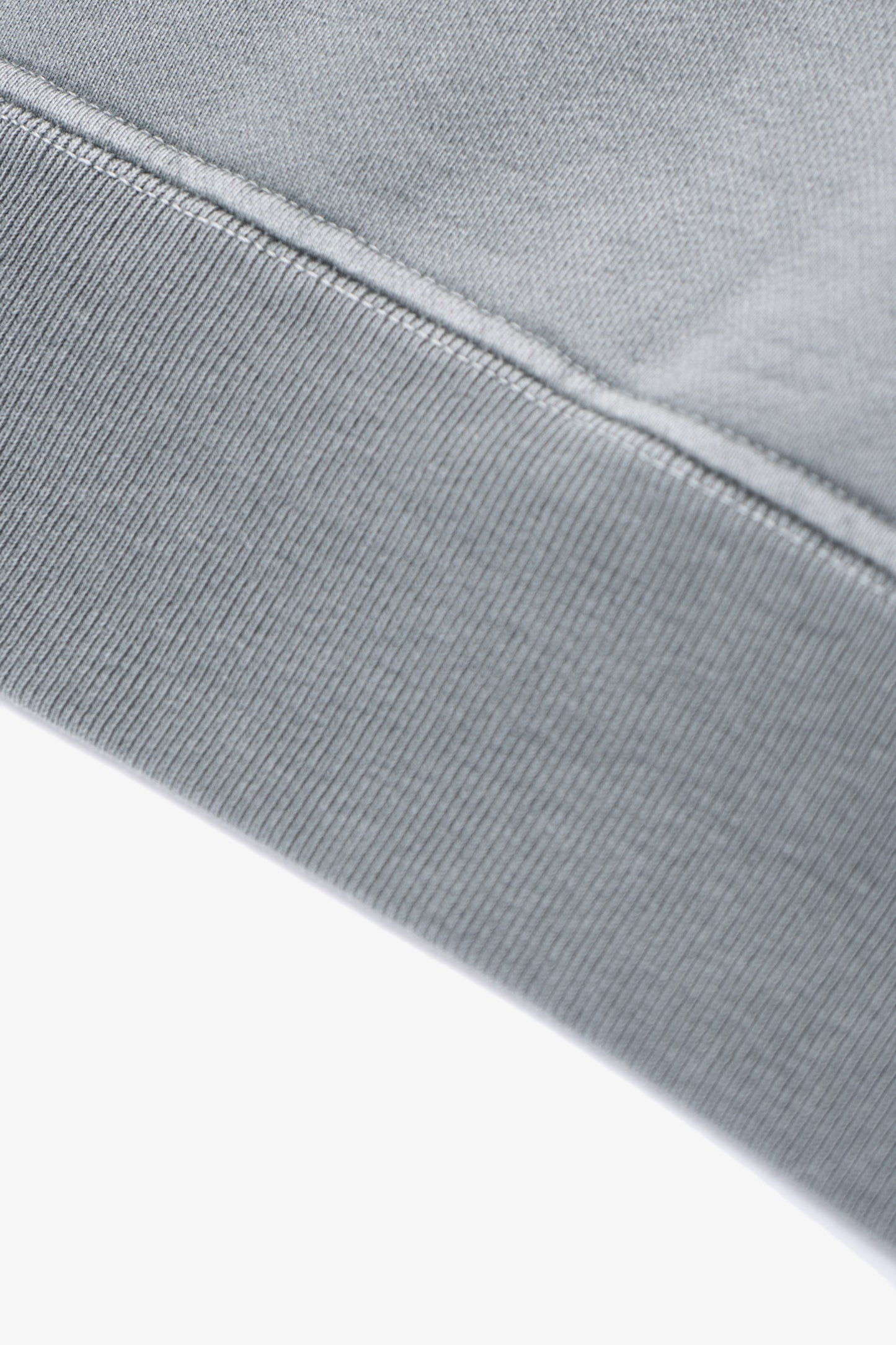 Close-up of waistband ribbing of LW620 Heavy Gusset Crewneck in pigment kelp