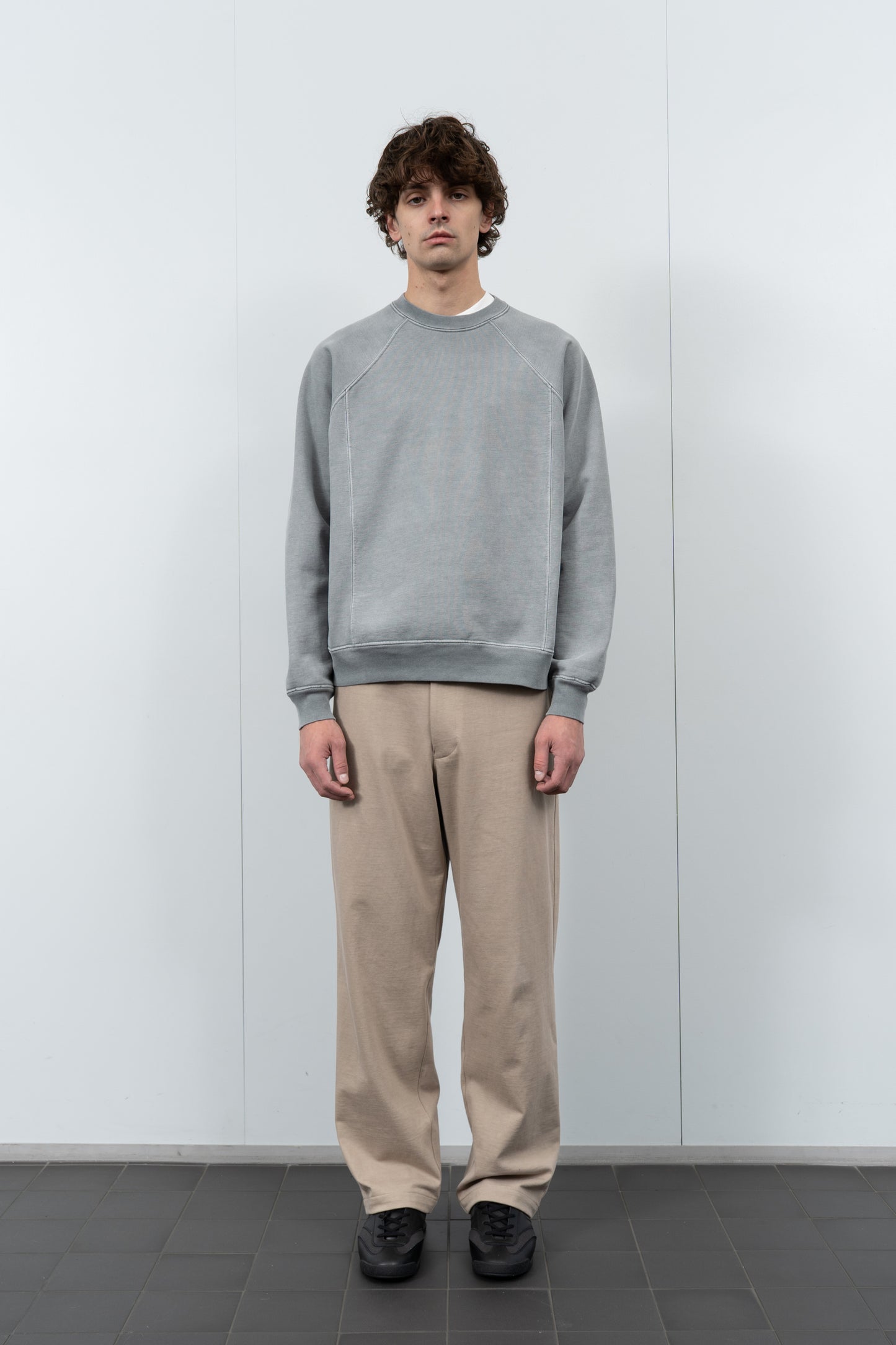 Model poses in LW620 Heavy Gusset Crewneck in pigment kelp