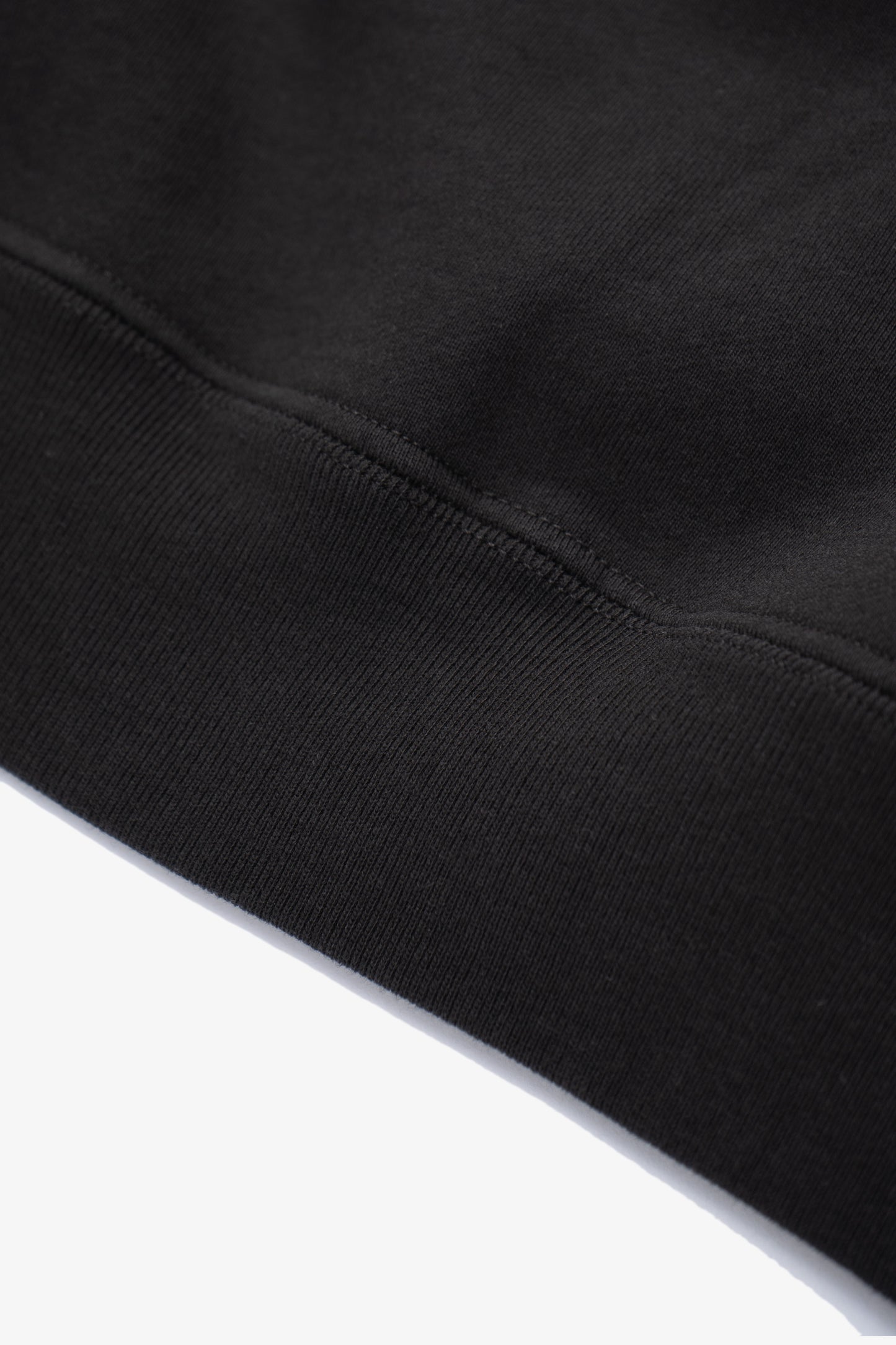 Close-up of waistband ribbing of LW620 Heavy Gusset Crewneck in shadow