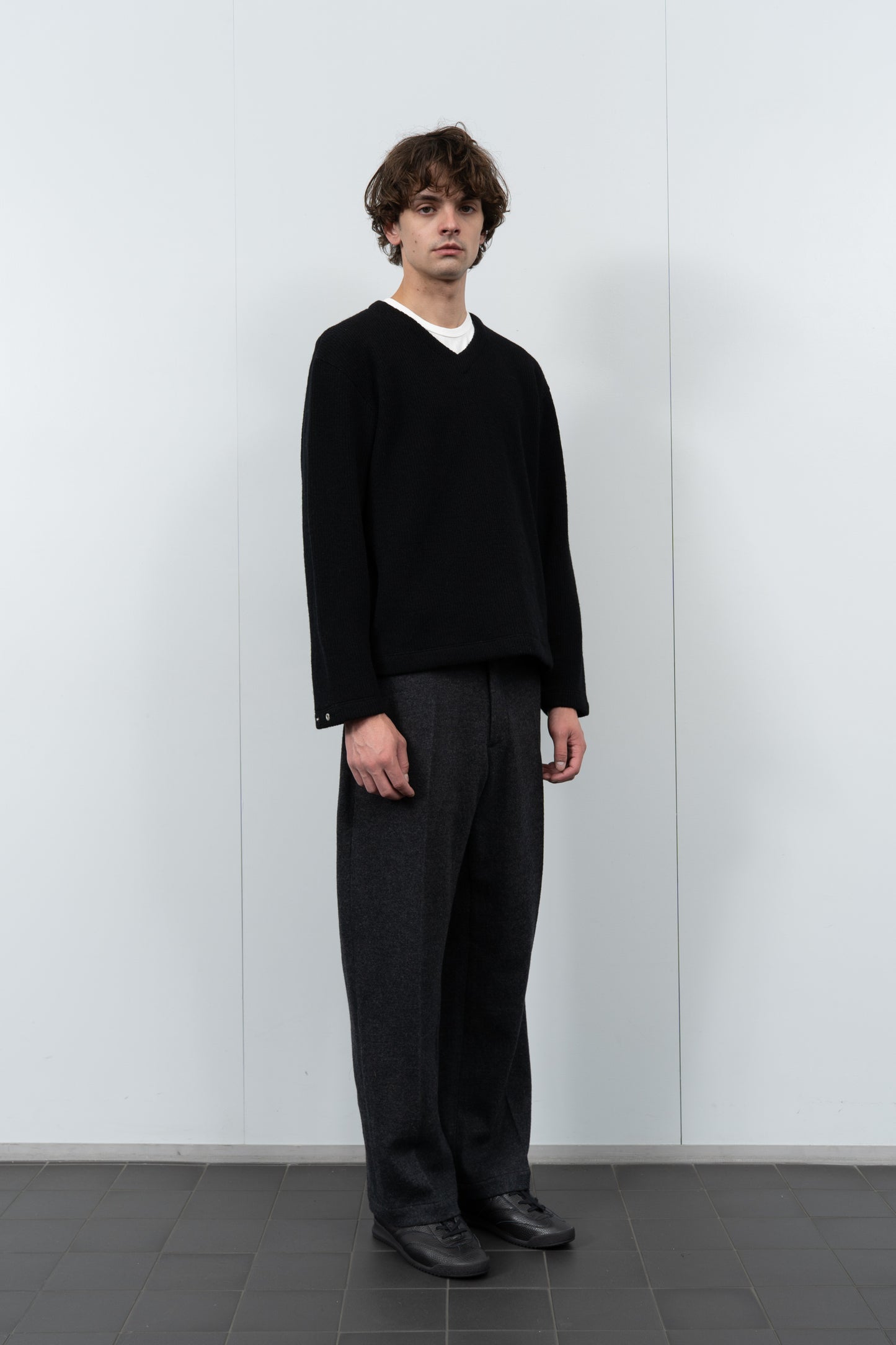 Model poses in LW770CW V Neck Snap Sweater in black