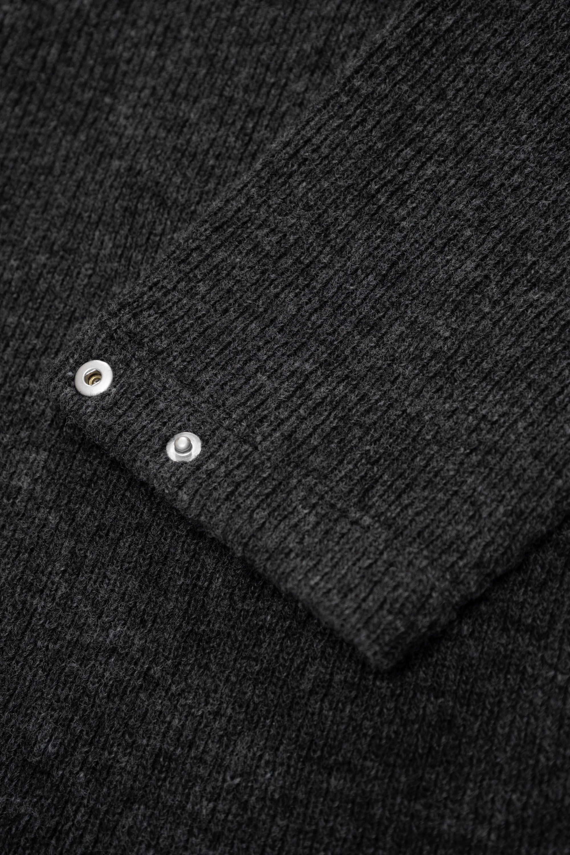 Close-up of rear waist of LW770CW V Neck Snap Sweater, showing snaps