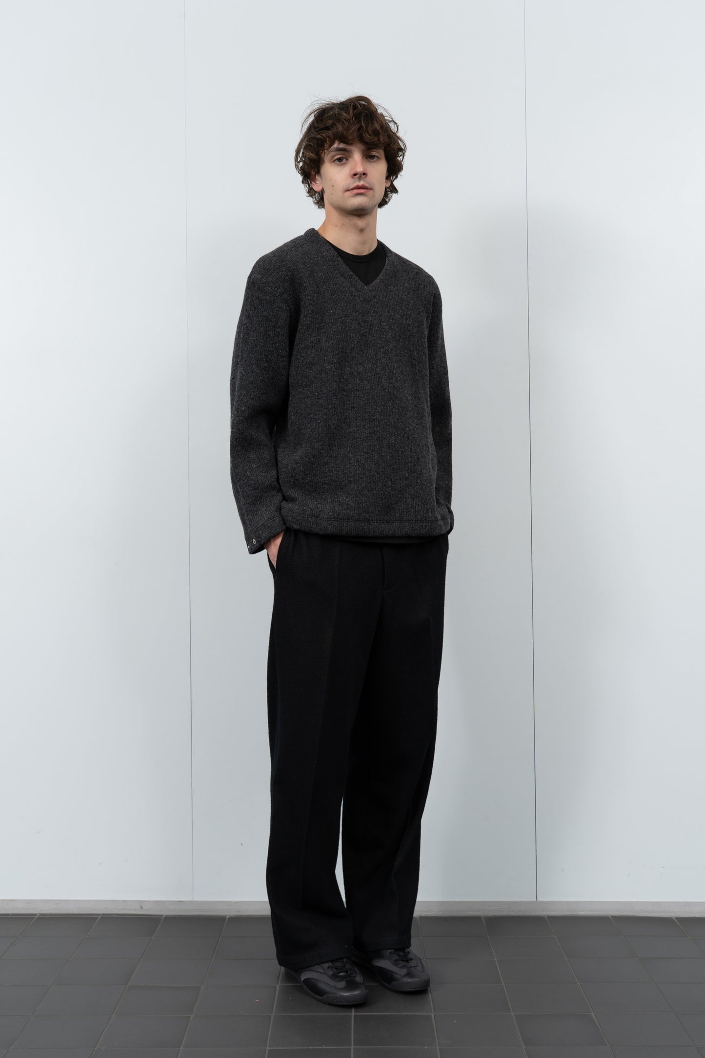 Model poses in LW770CW V Neck Snap Sweater in charcoal