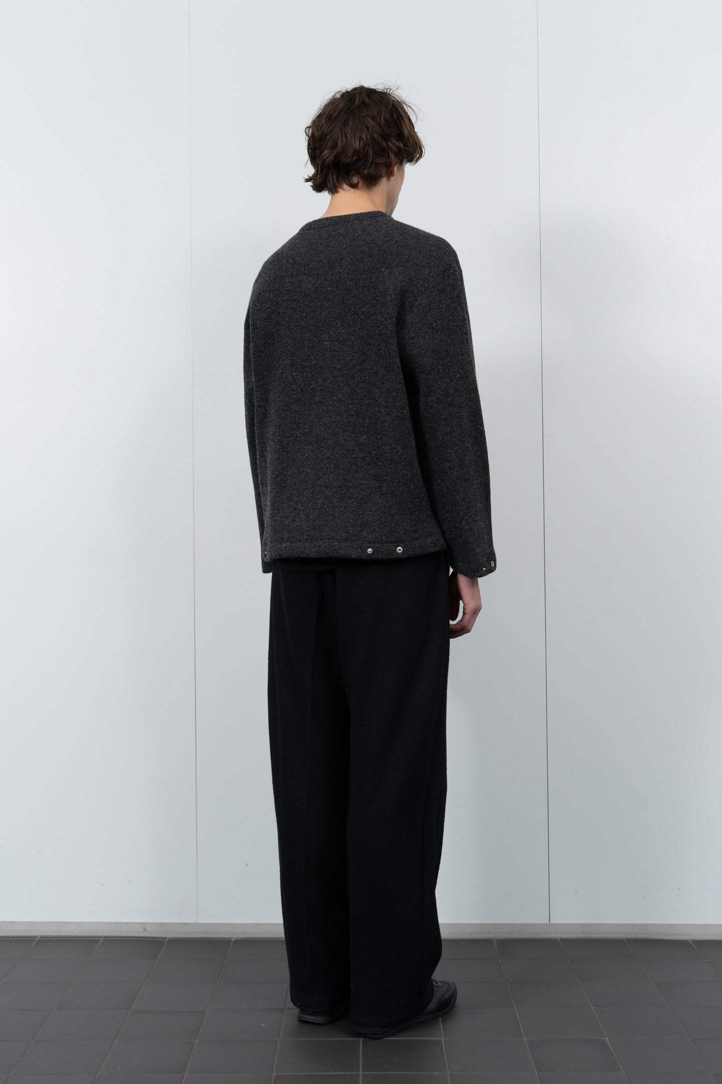 Model poses in LW770CW V Neck Snap Sweater in charcoal