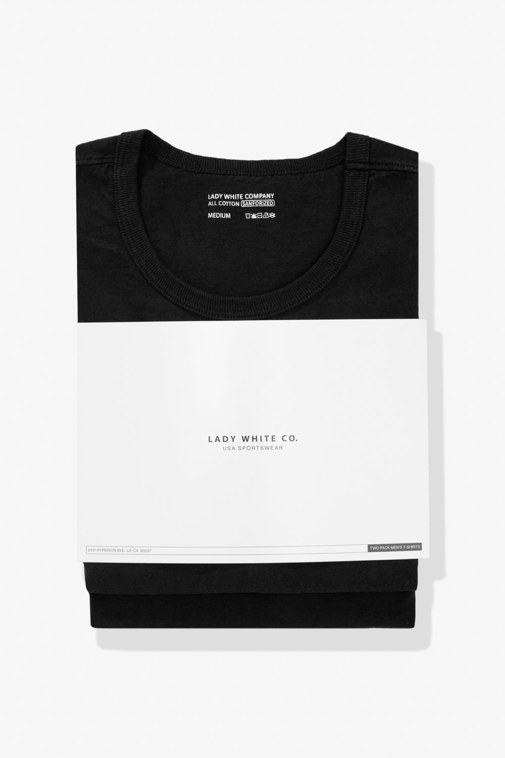 Two LW101 Our T-shirts, stacked on top of each other, enclosed in a belly band