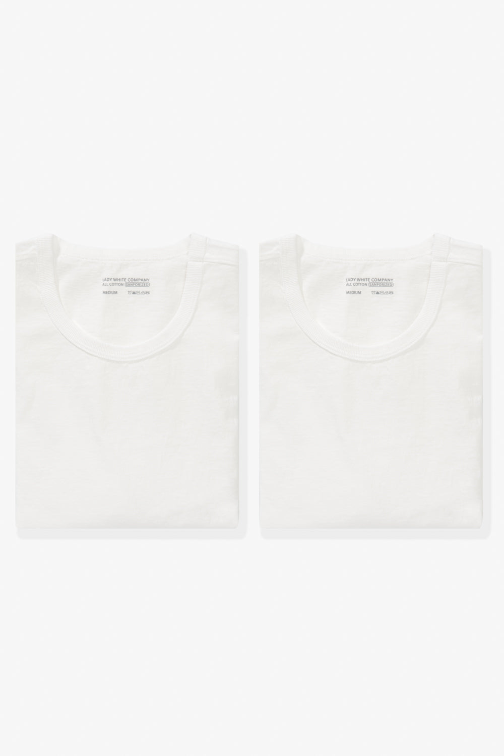 Two folded LW101 Our T-shirts in white side by side
