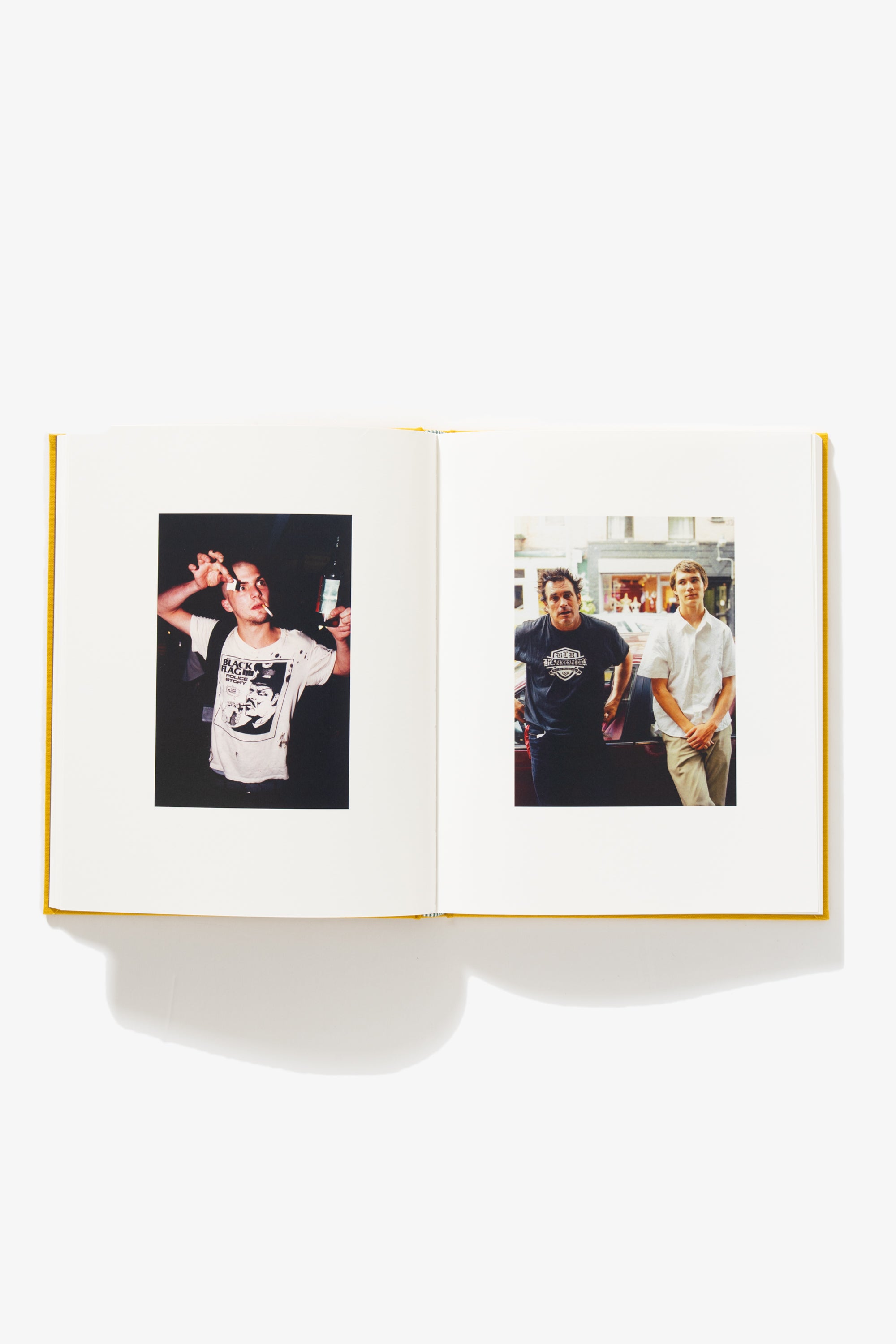 Spread of Everybody’s Guilty, No One’s To Blame. Verso shows a man in a Black Flag “Police Story” t-shirt. The lit cigarette in his mouth slanted; a bottle of beer pinched between his thumb and forefinger; and a small tab of paper in the other hand. Recto shows two men posing against a car, one older, one younger.