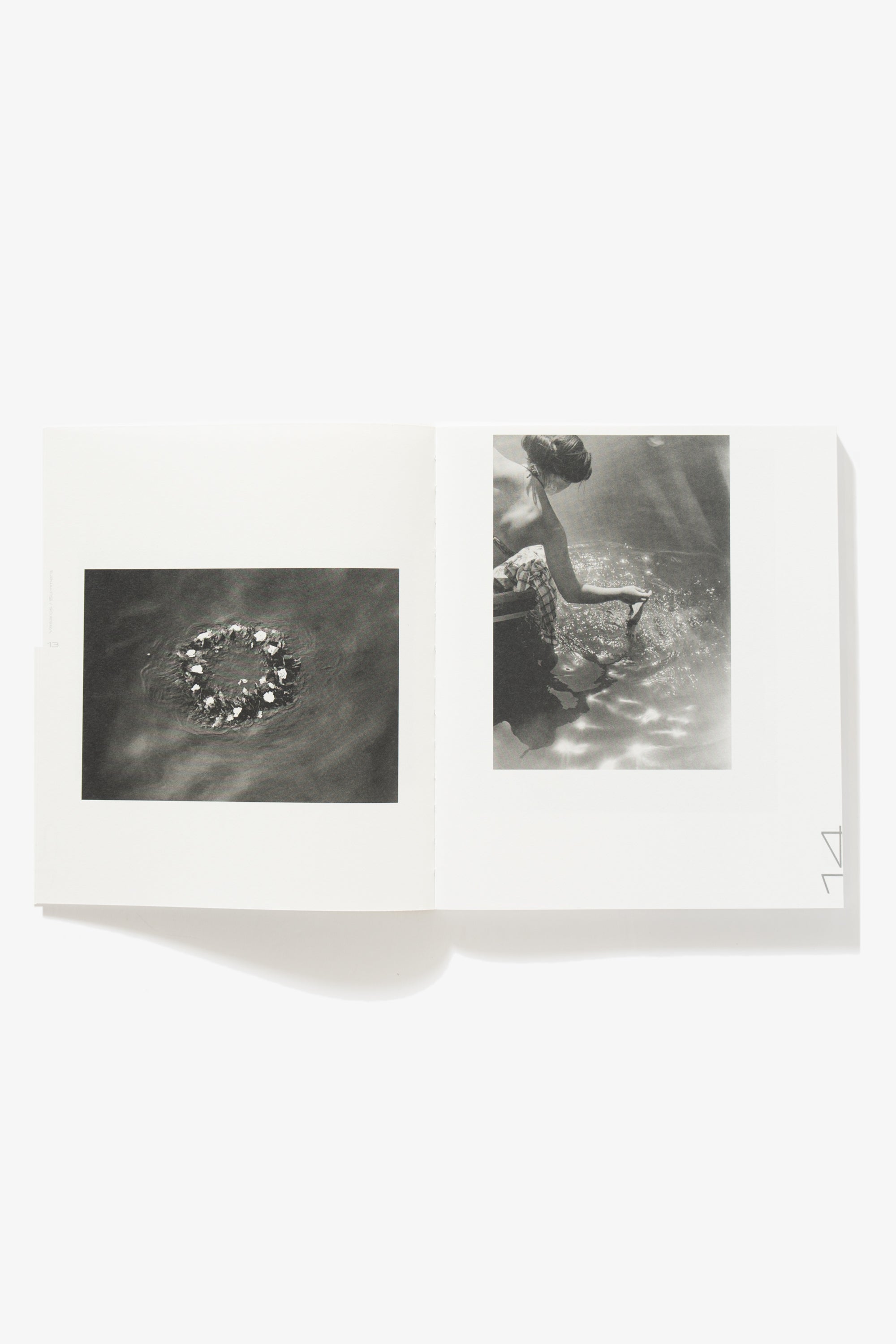 Spread of 85 Vasaros. Verso shows an aerial image of a ring of flowers in water. Recto depicts a woman kneeling over water running her hand through the glimmering surface.