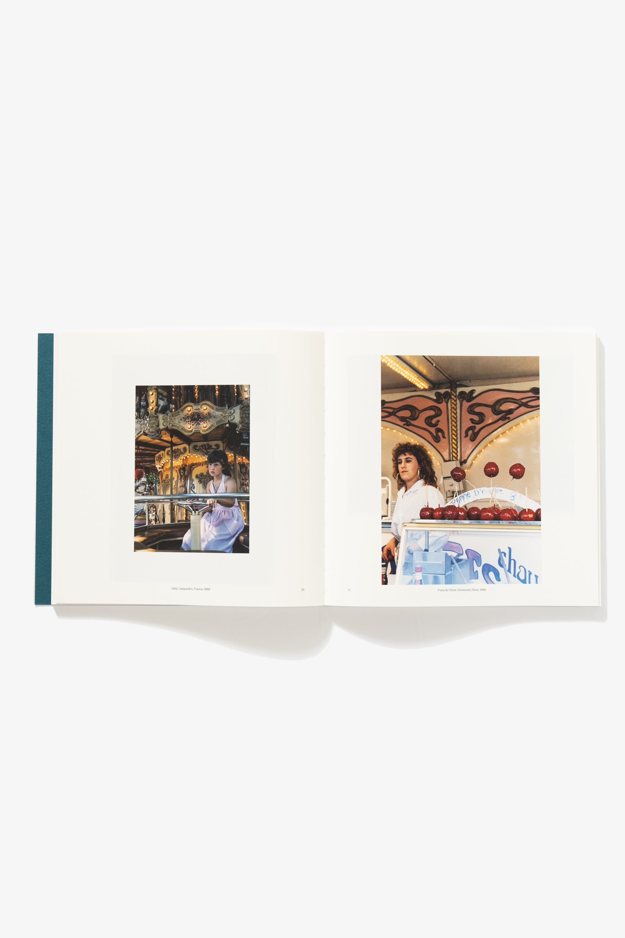 Spread of A World Observed. Verso depicts a young girl on an amusement park ride, looking bored or distracted into the distance. Caption: “Sete. Languedoc, France, 1989.” Recto depicts a woman standing in a sweets shop, candied apples in the foreground. Captioned: “Foire du Trone, Vincennes, Paris, 1990.” 