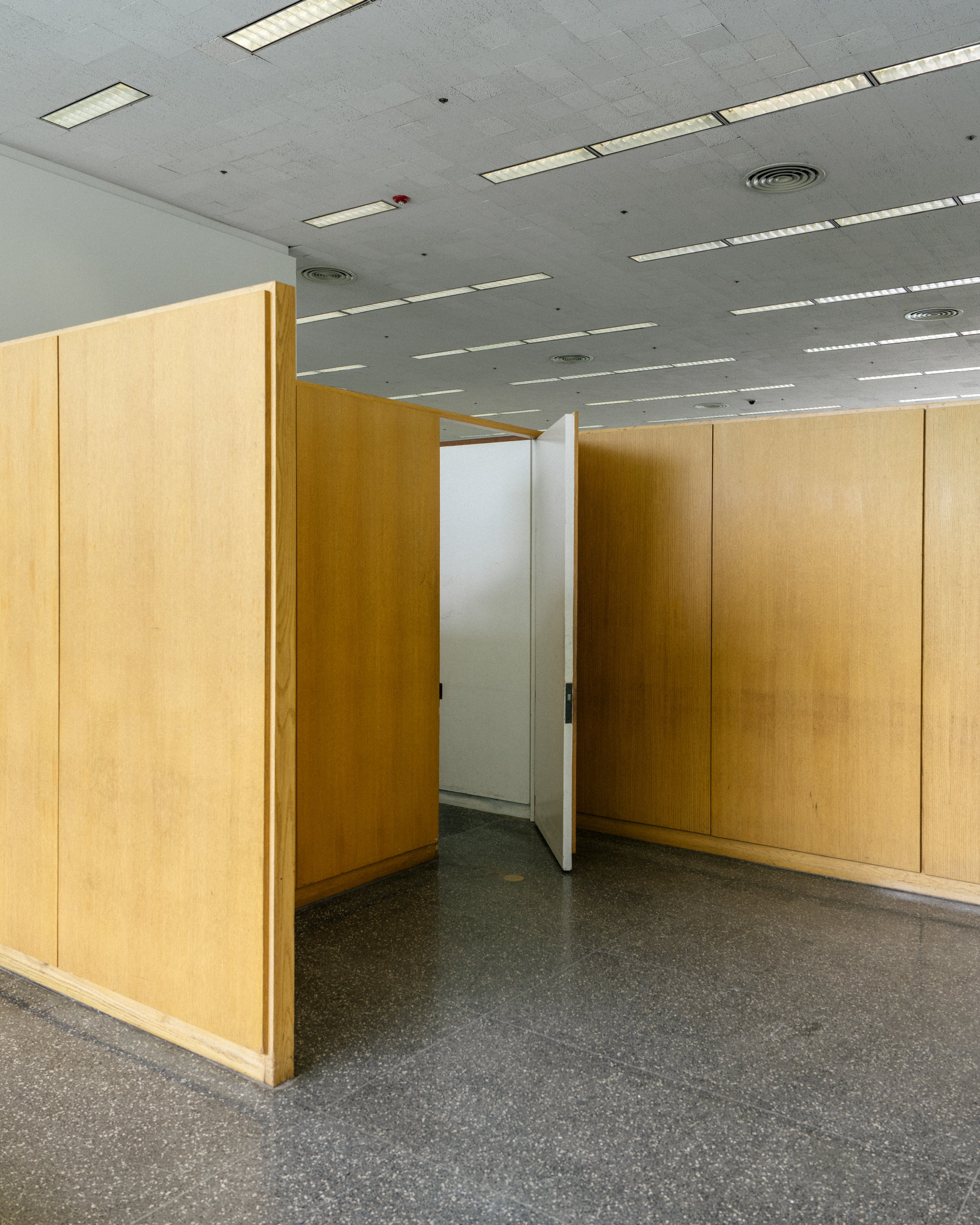 Interior of a room with a door ajar. Taken at the S.R. Crown Hall.