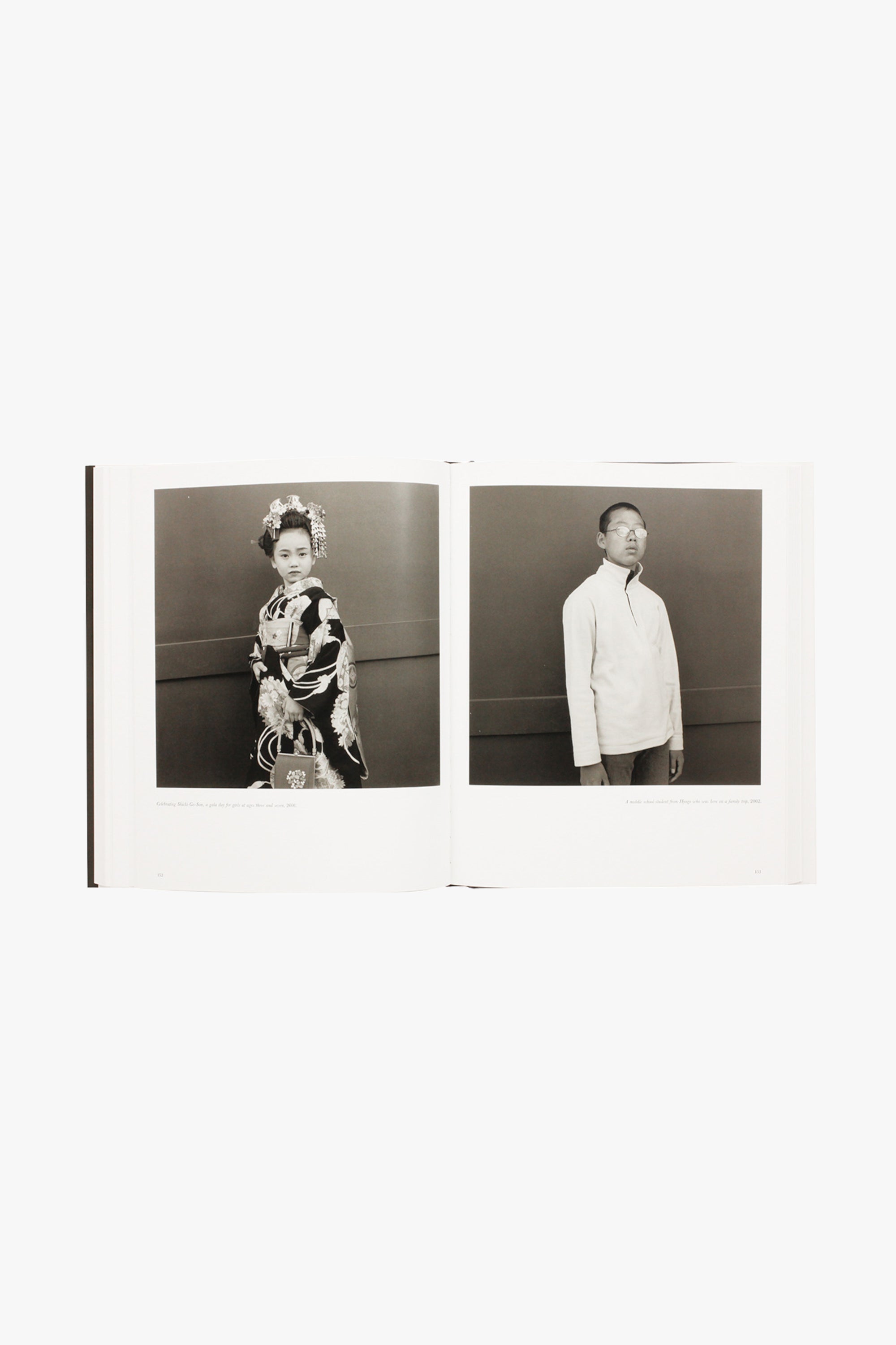 Photograph from Hiroh Kikai's "Asakusa Portraits." Verso shows a woman in a kimono standing against a dark background. Recto shows a young man in a quarter-zip sweatshirt standing against a dark background.