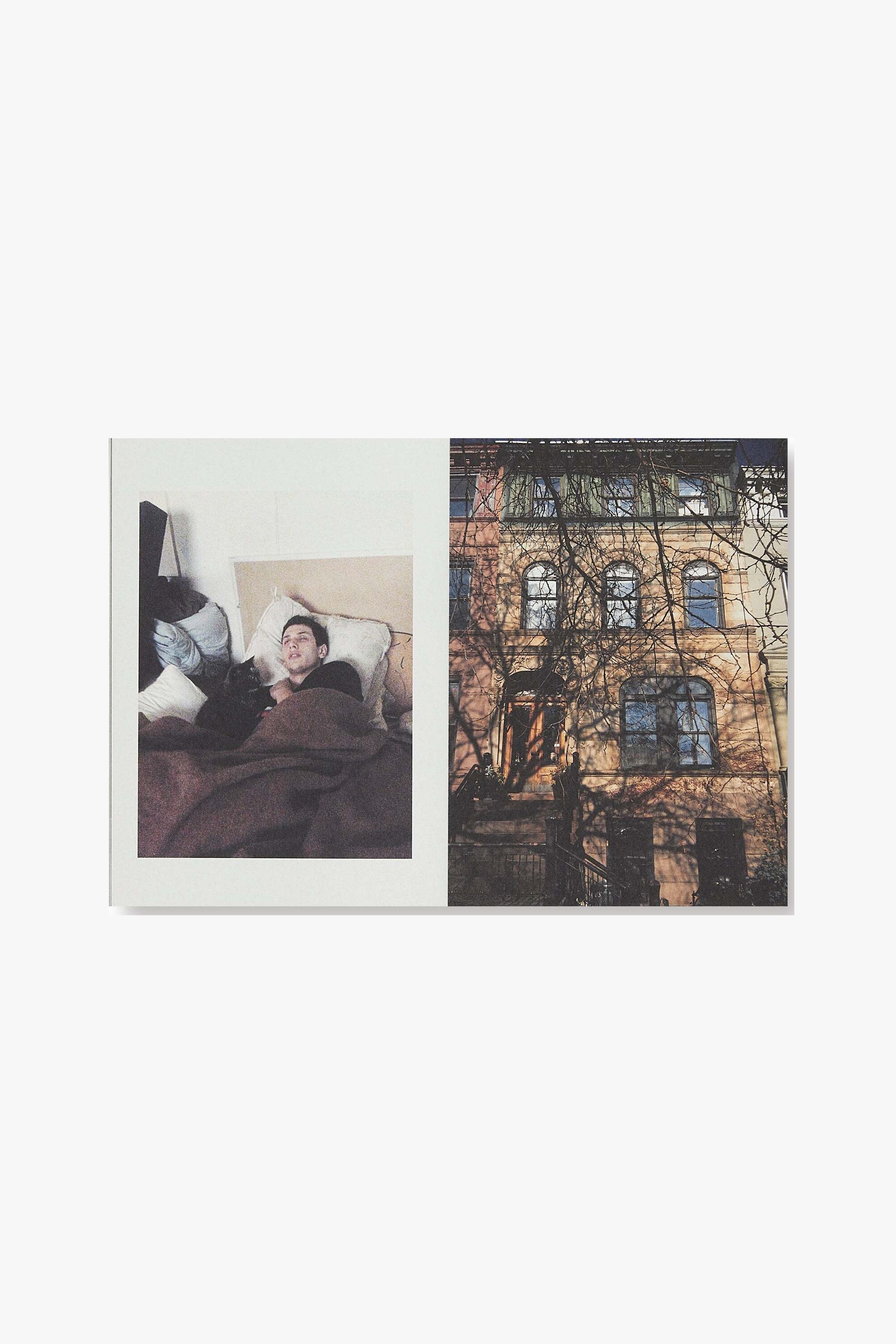 A full spread of "Candyland." Verso is a full-page photograph of a male figure sitting up partially in bed, attended by a black cat. Recto is a full-frame photograph of the front of building with arc windows, barren tree branches in the foreground.