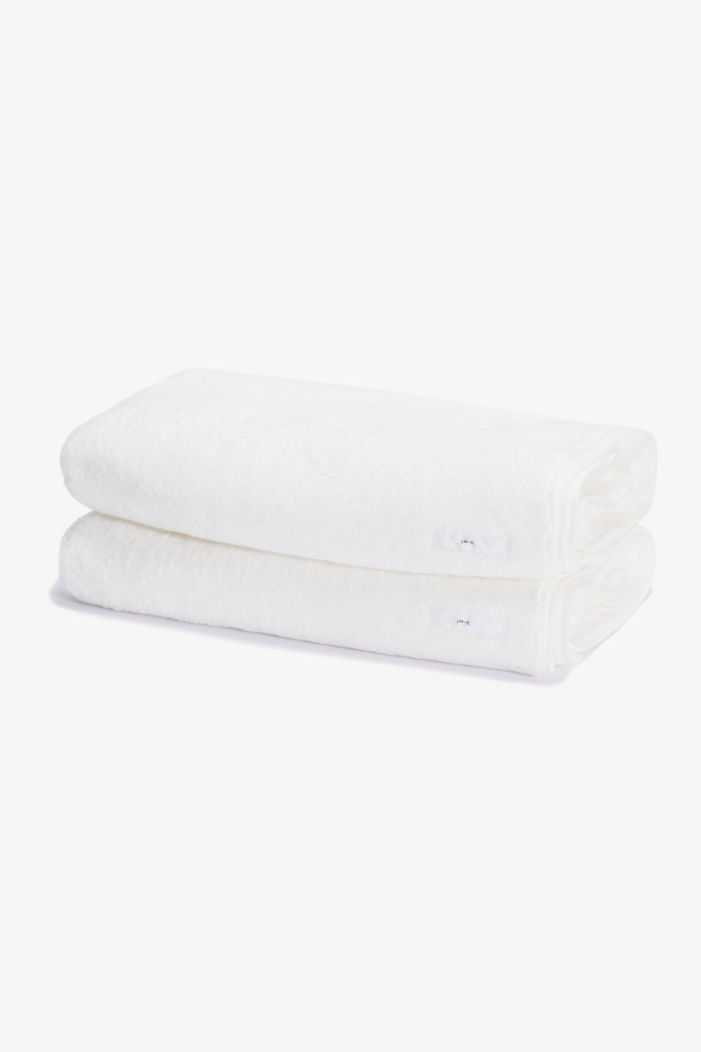 Two white folded towels, stacked on top of each other