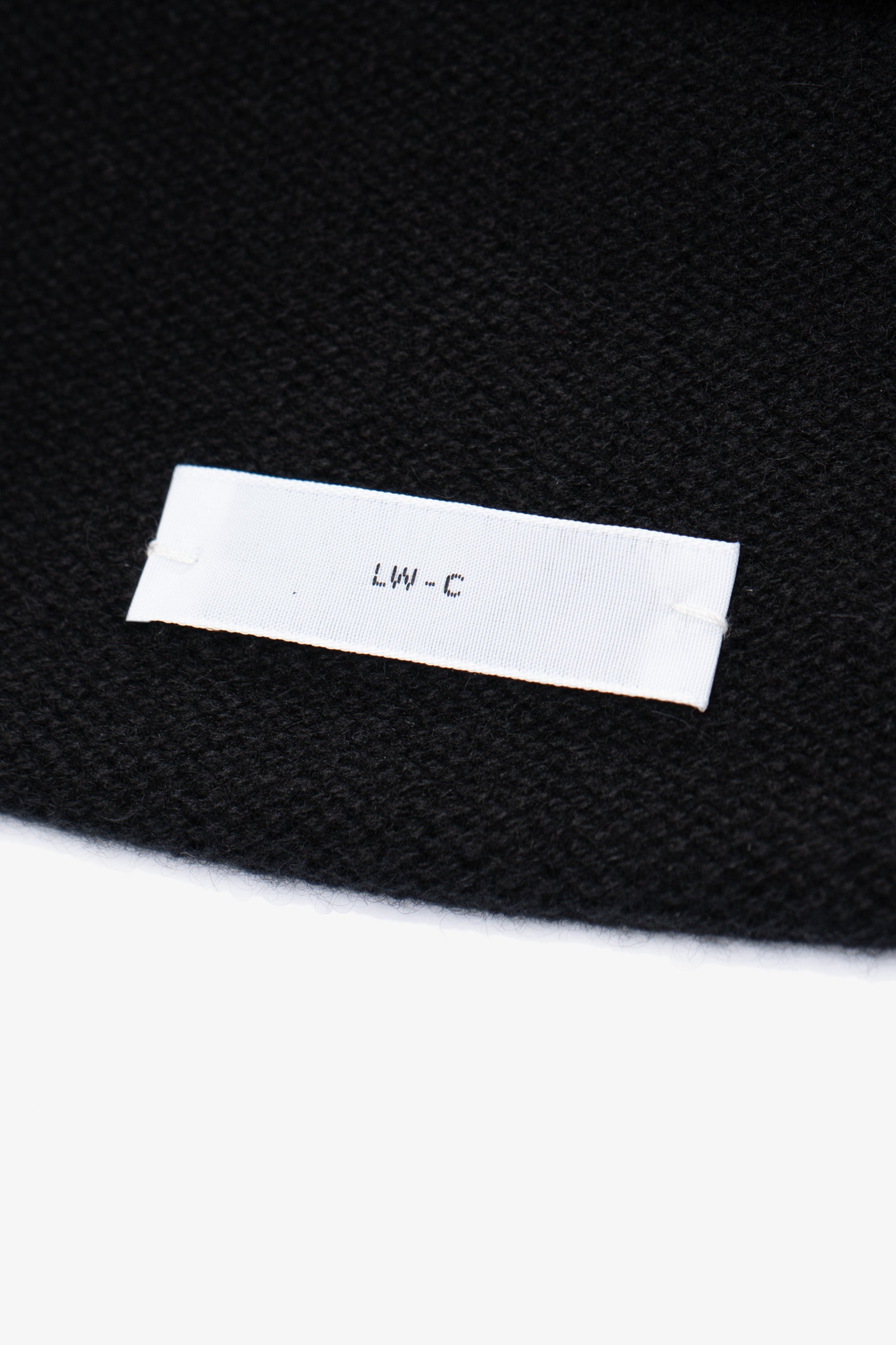 Close-up of fabric and tag of LW036 Ambrosia Beanie in black