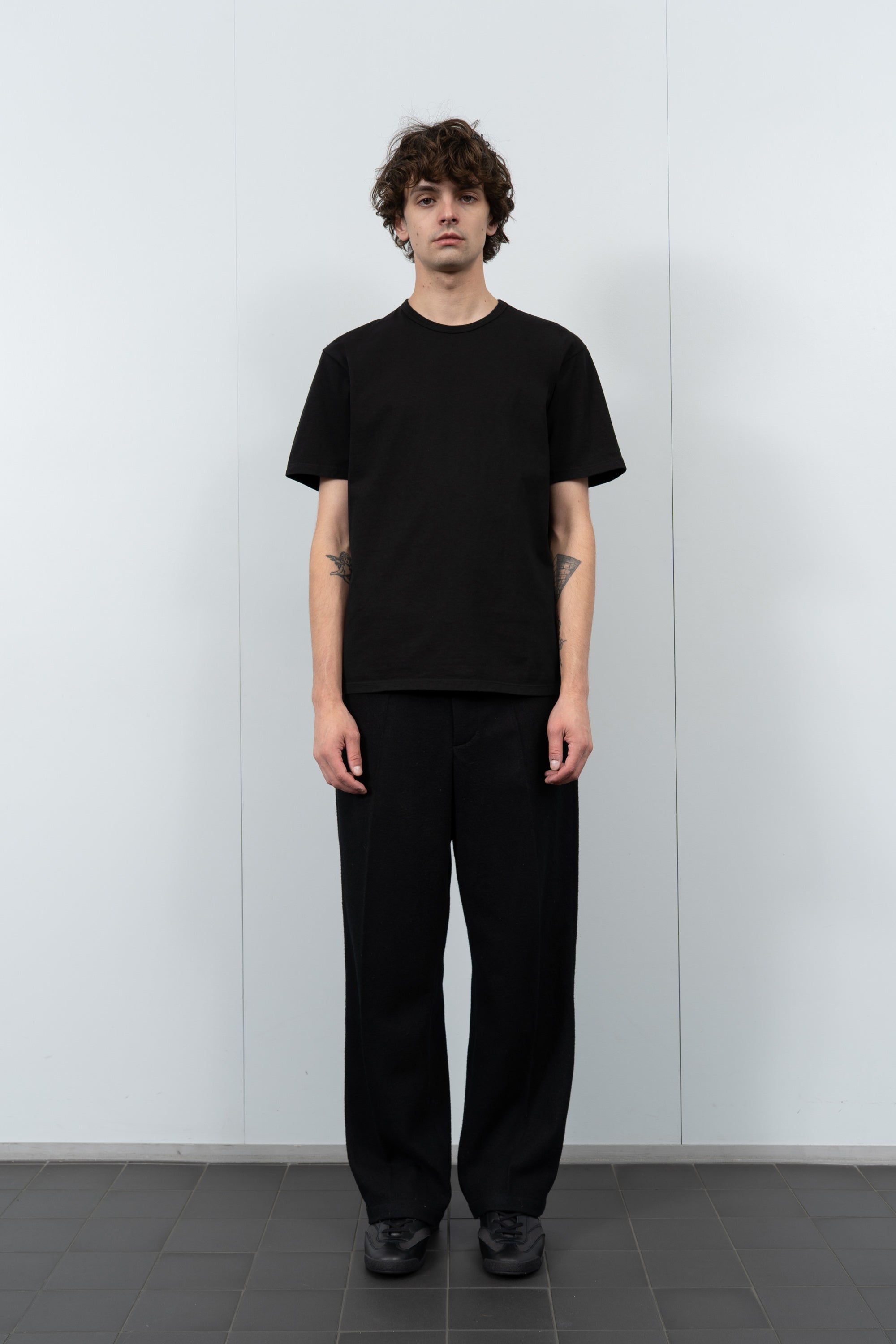 Model poses in LW101 Our T-shirt in black