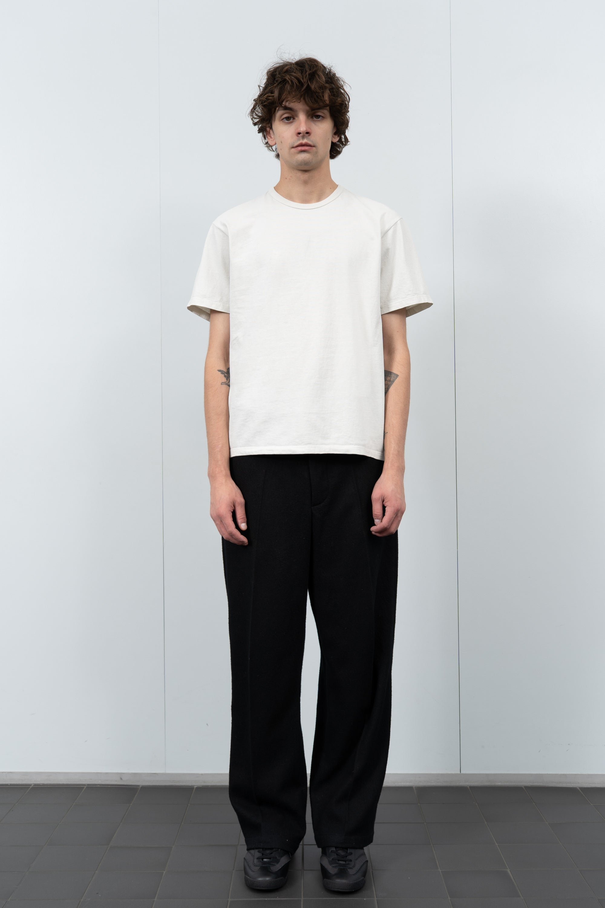 Model poses in LW101 Our T-shirt in off white