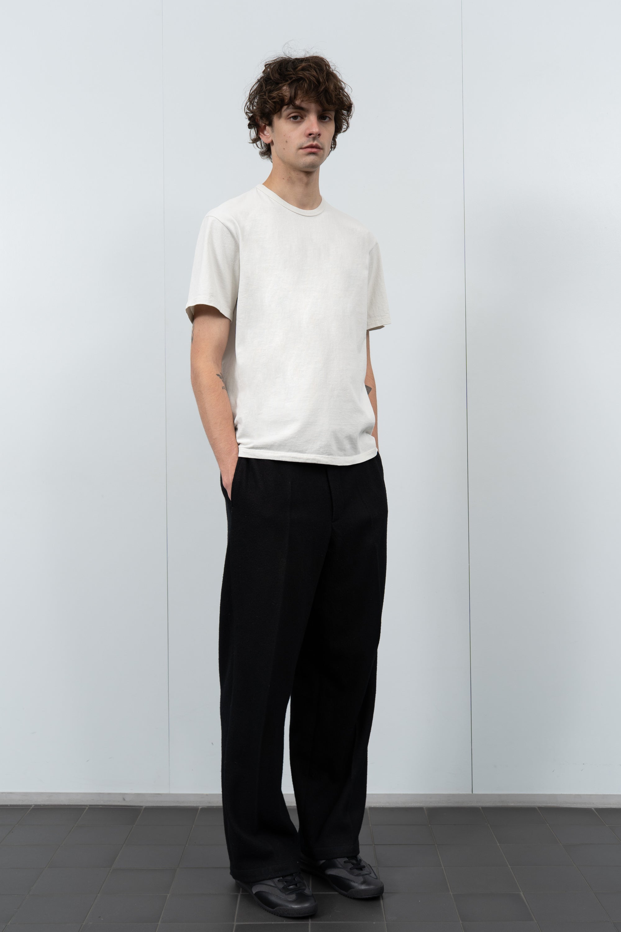 Model poses in LW101 Our T-shirt in off white