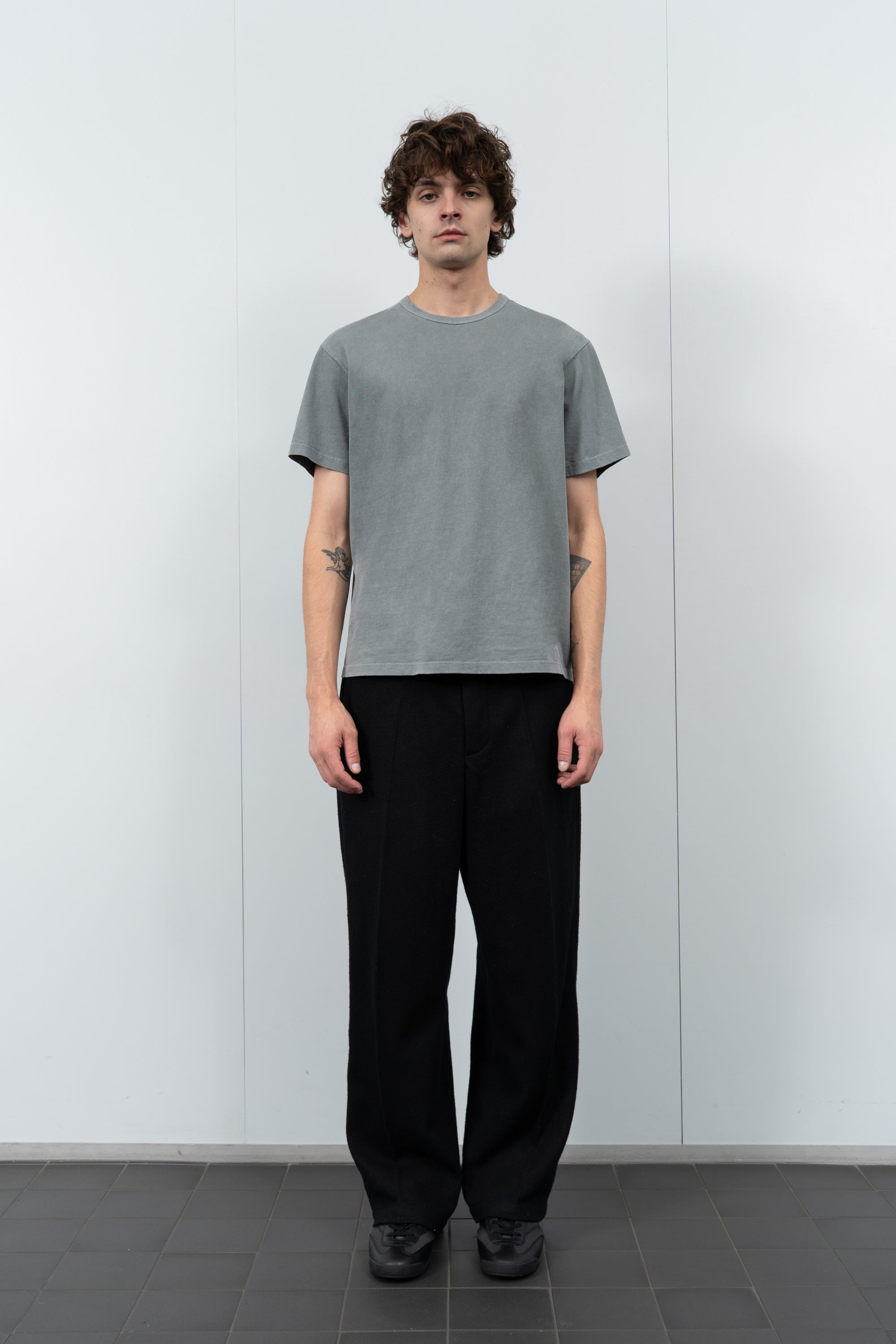 Model poses in LW101 Our T-shirt in pigment kelp