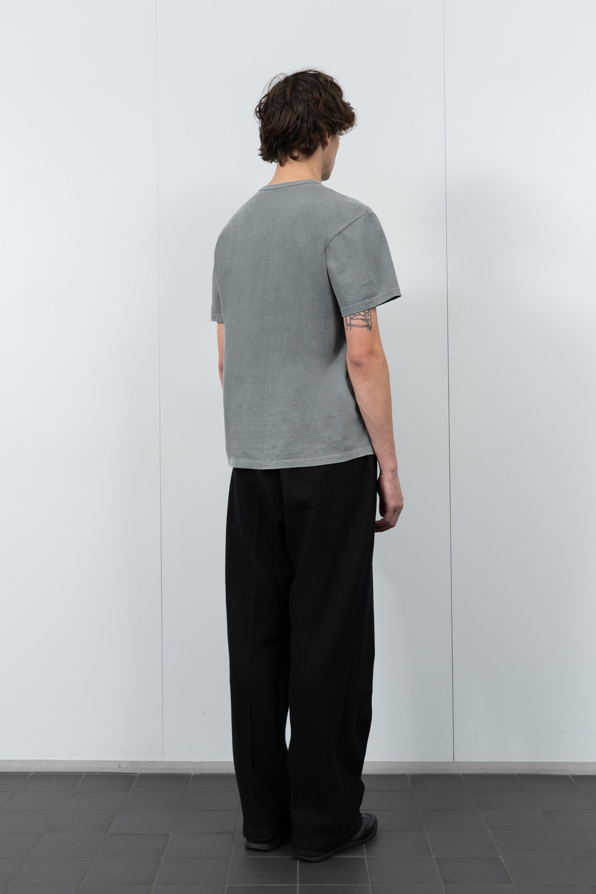 Model poses in LW101 Our T-shirt in pigment kelp