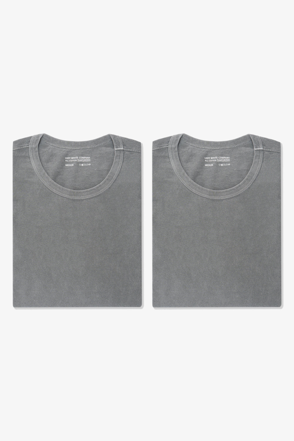 Two folded LW101 Our T-shirts in pigment kelp side by side