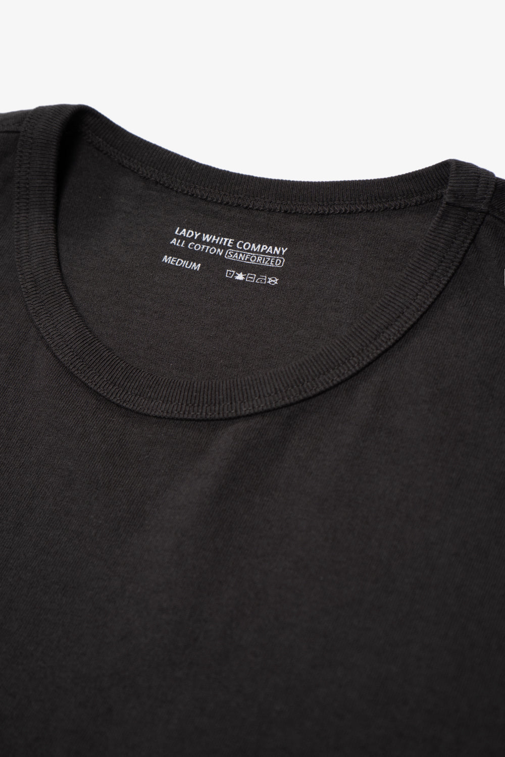 Two LW101 Our T-shirts stacked on top of each other, inside of a belly band