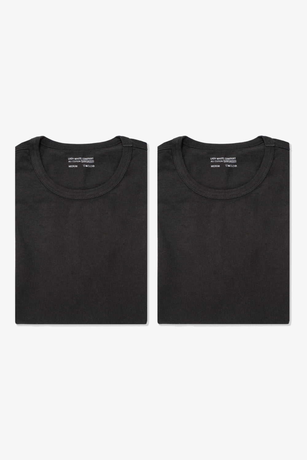 Two folded LW101 Our T-shirts in shadow side by side