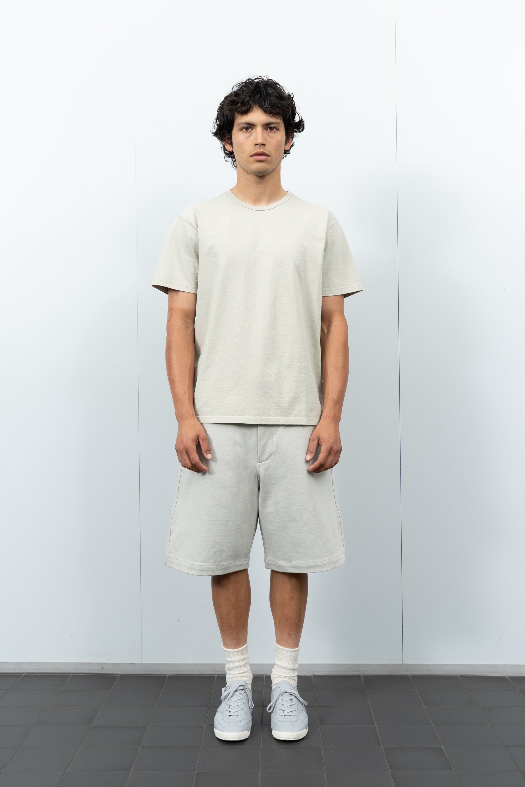 Front-facing on-model photograph of model wearing LW101 Our T-shirt in Swiss Natural