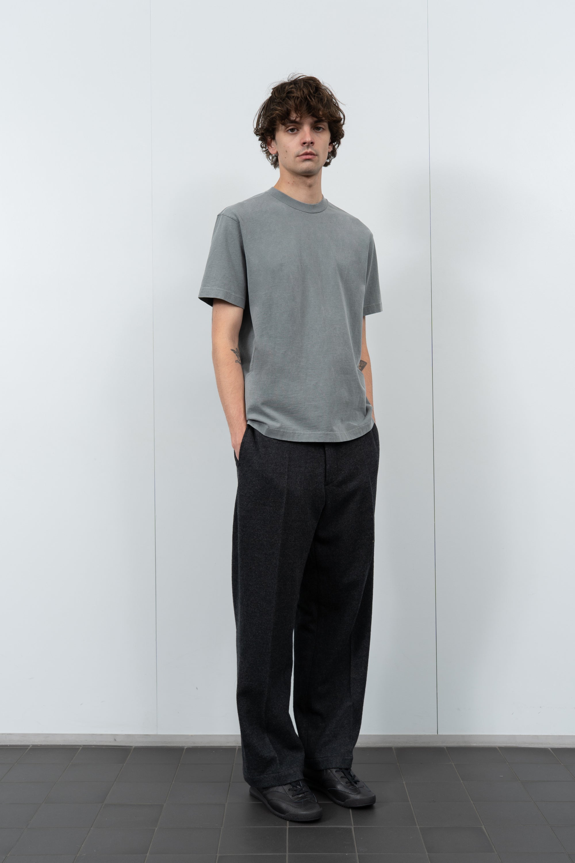 Model poses in LW102 Municipal T-shirt in pigment kelp