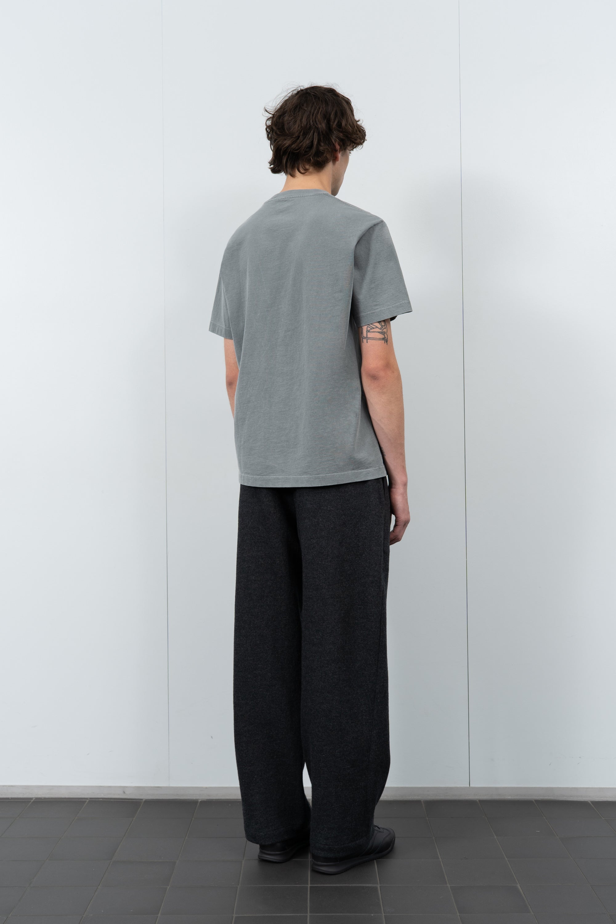 Model poses in LW102 Municipal T-shirt in pigment kelp