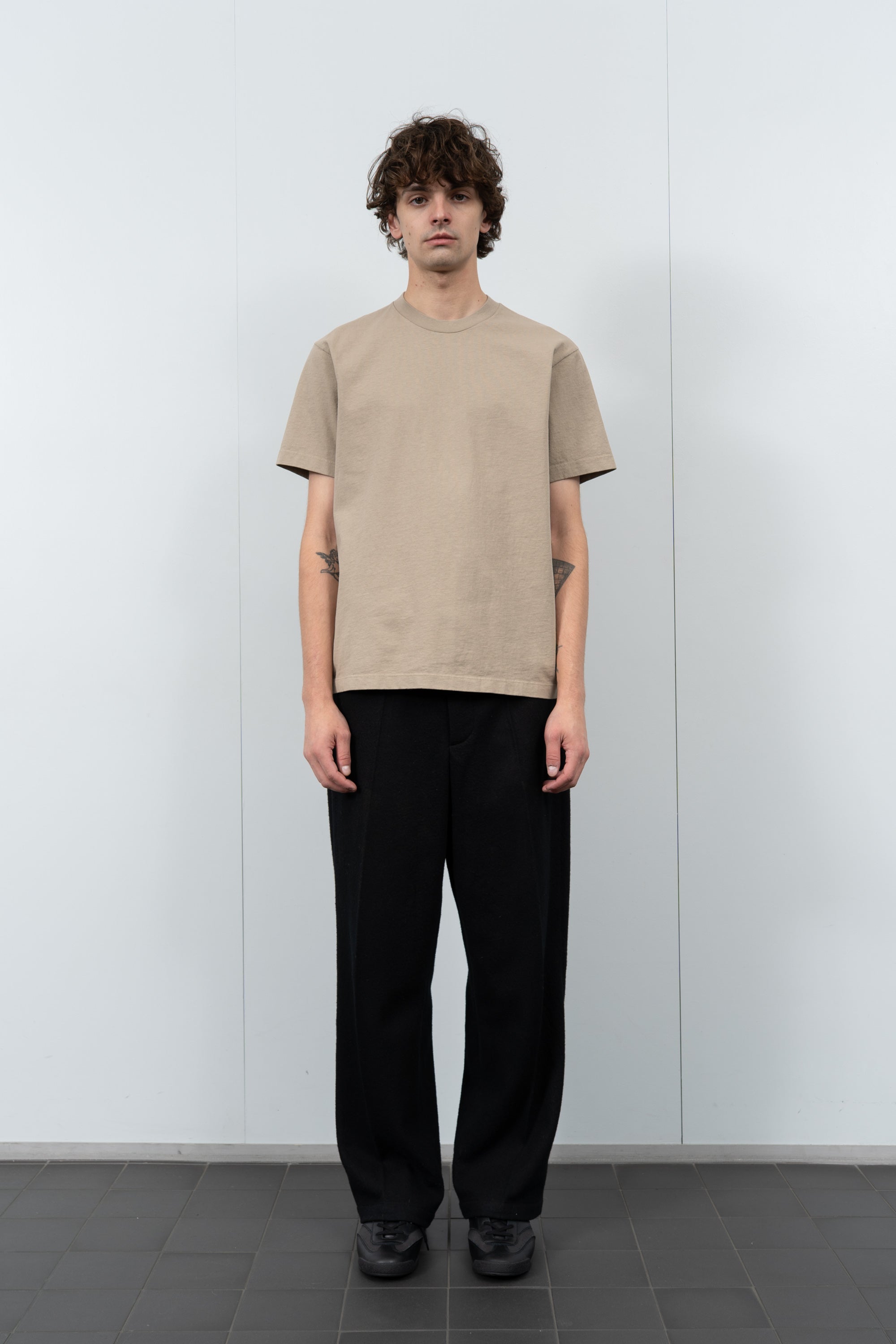 Model poses in LW102 Municipal T-shirt in sand