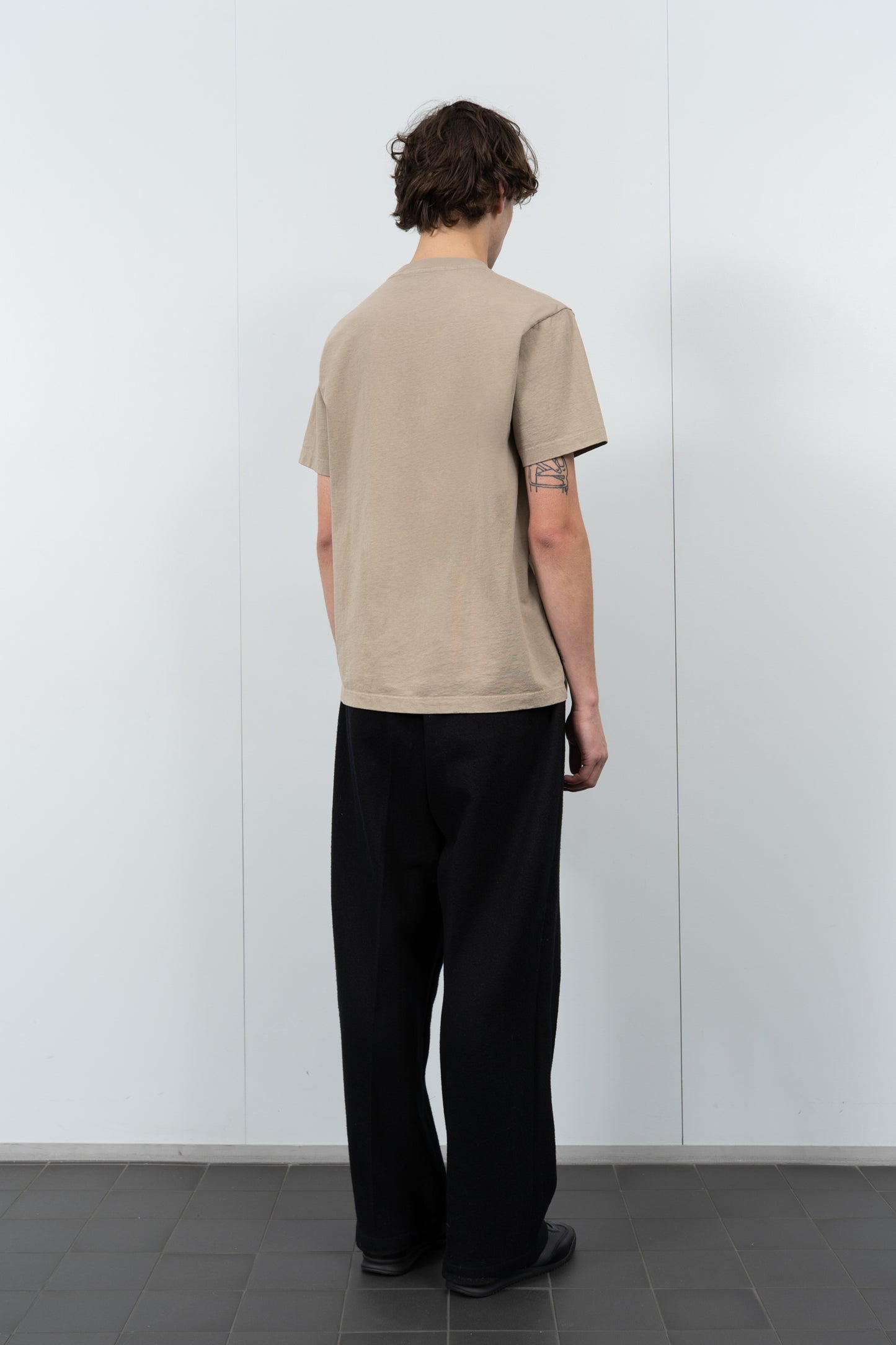 Model poses in LW102 Municipal T-shirt in sand