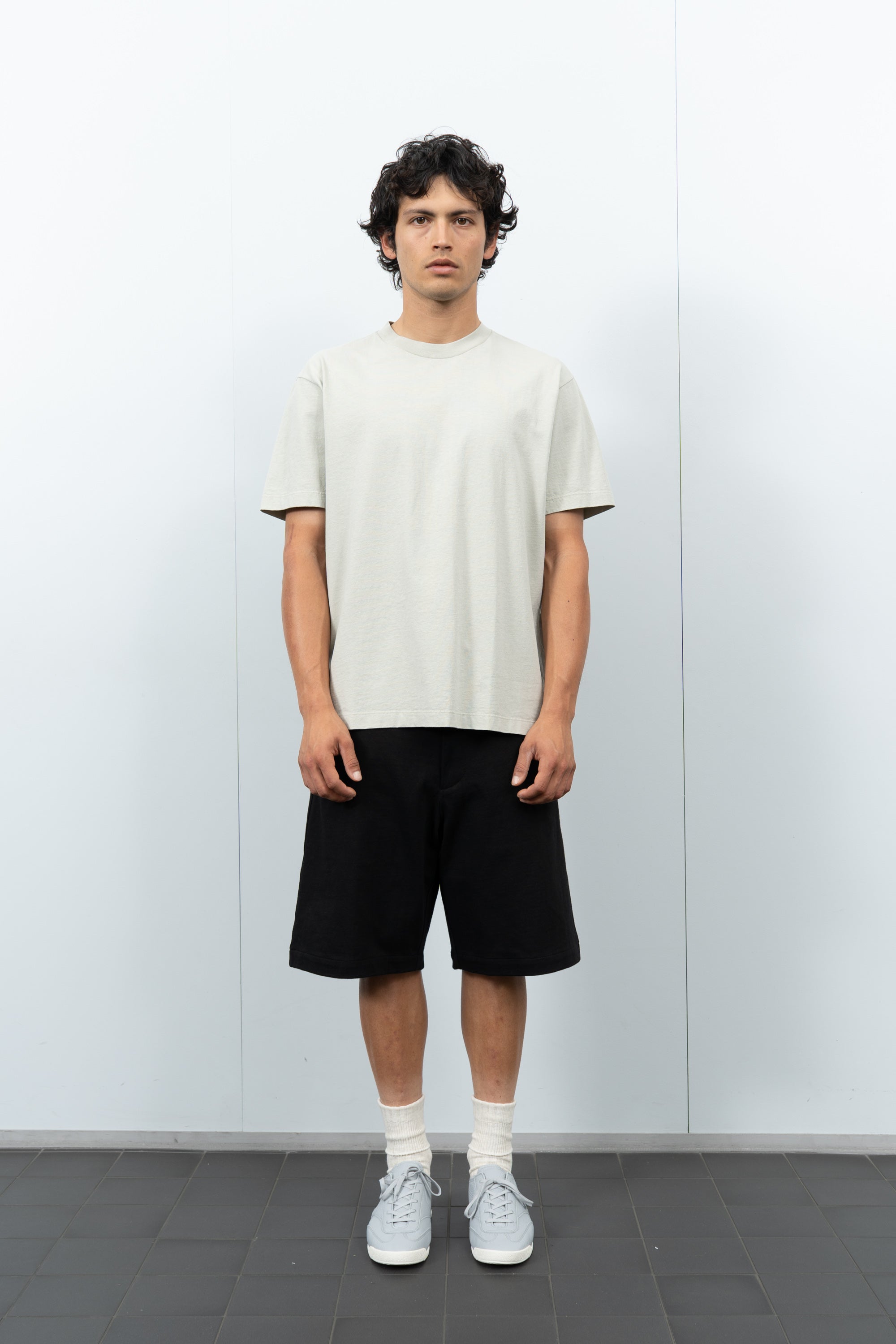 Front-facing on-model photograph of model wearing LW102 Municipal T-shirt in Swiss Natural