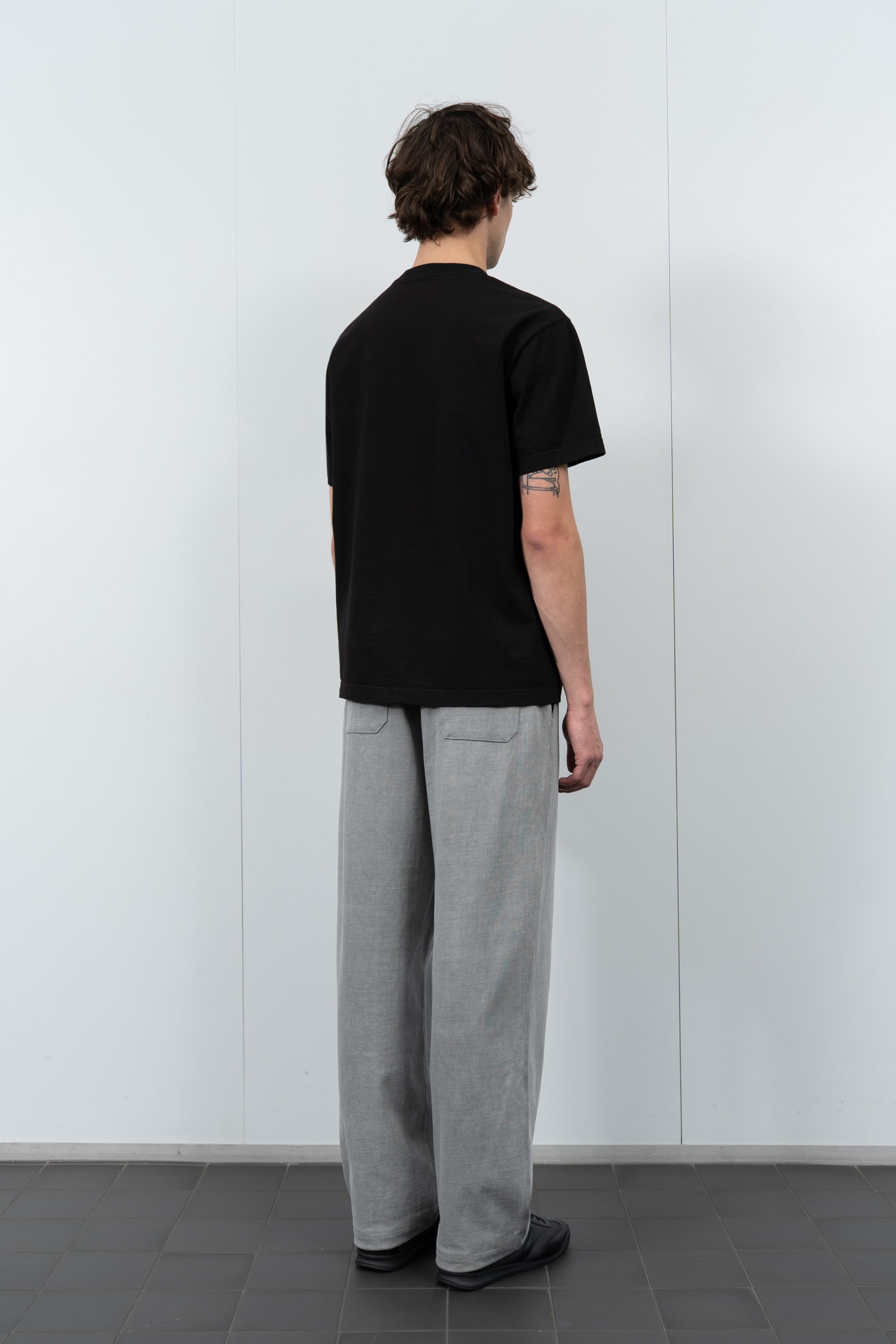 Model poses in LW103 Municipal Pocket T-shirt in black