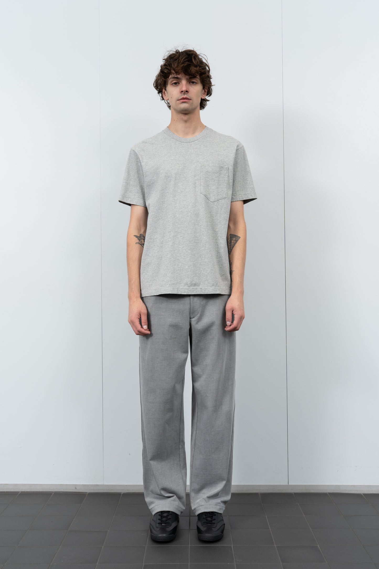 Model poses in LW103 Municipal Pocket T-shirt in heather gray