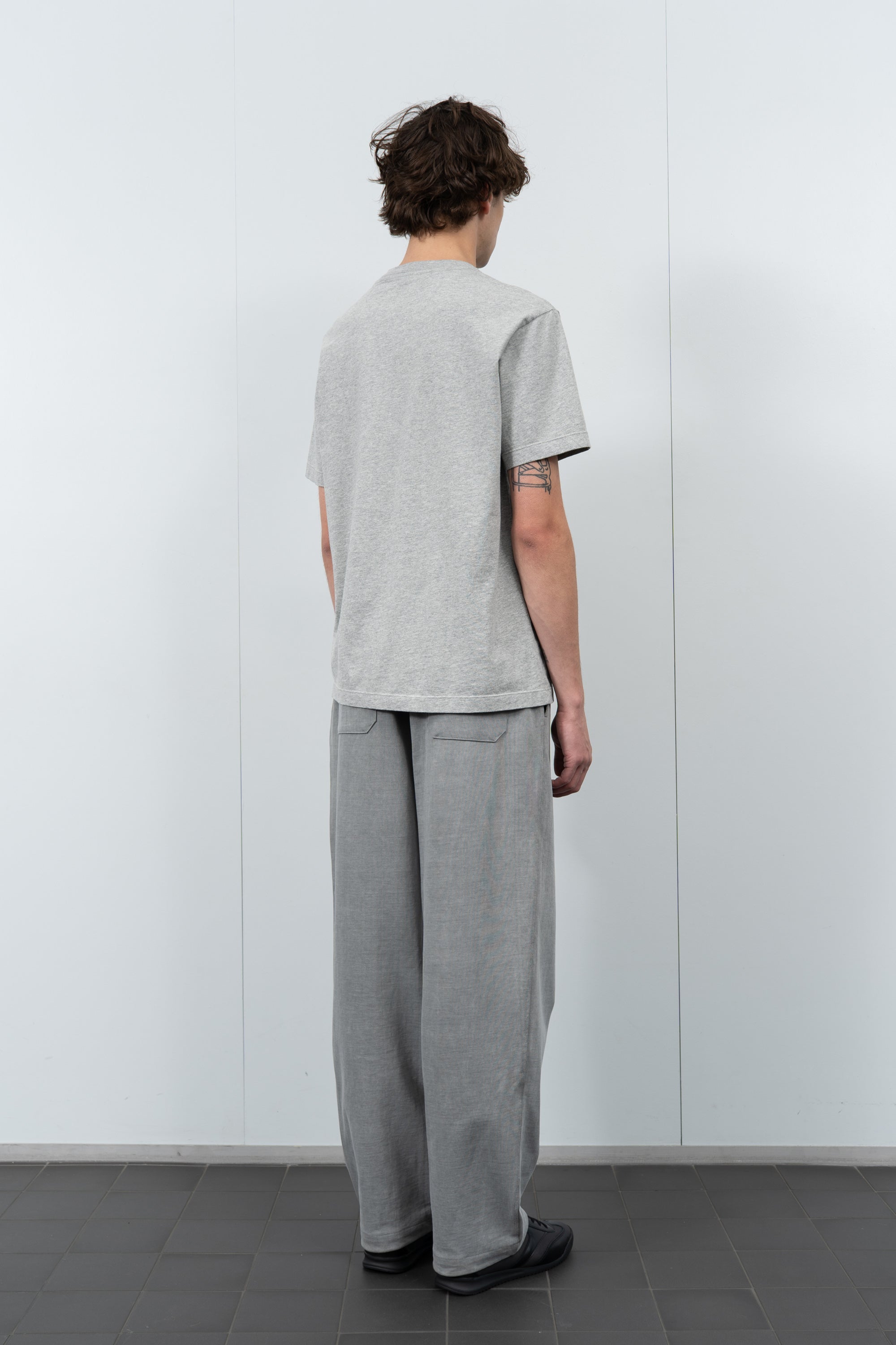 Model poses in LW103 Municipal Pocket T-shirt in heather gray