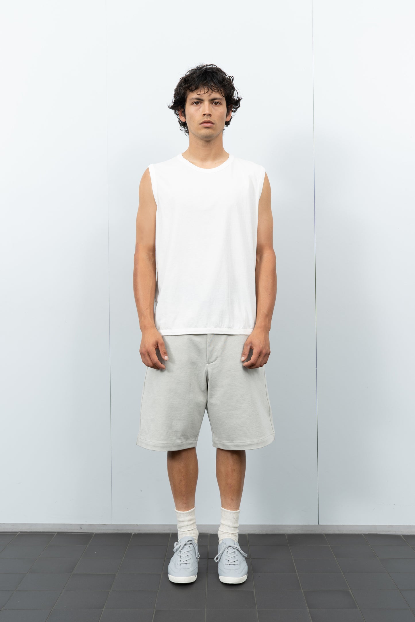 Front-facing on-model photograph of model wearing LW106 Sleeveless T-shirt in White