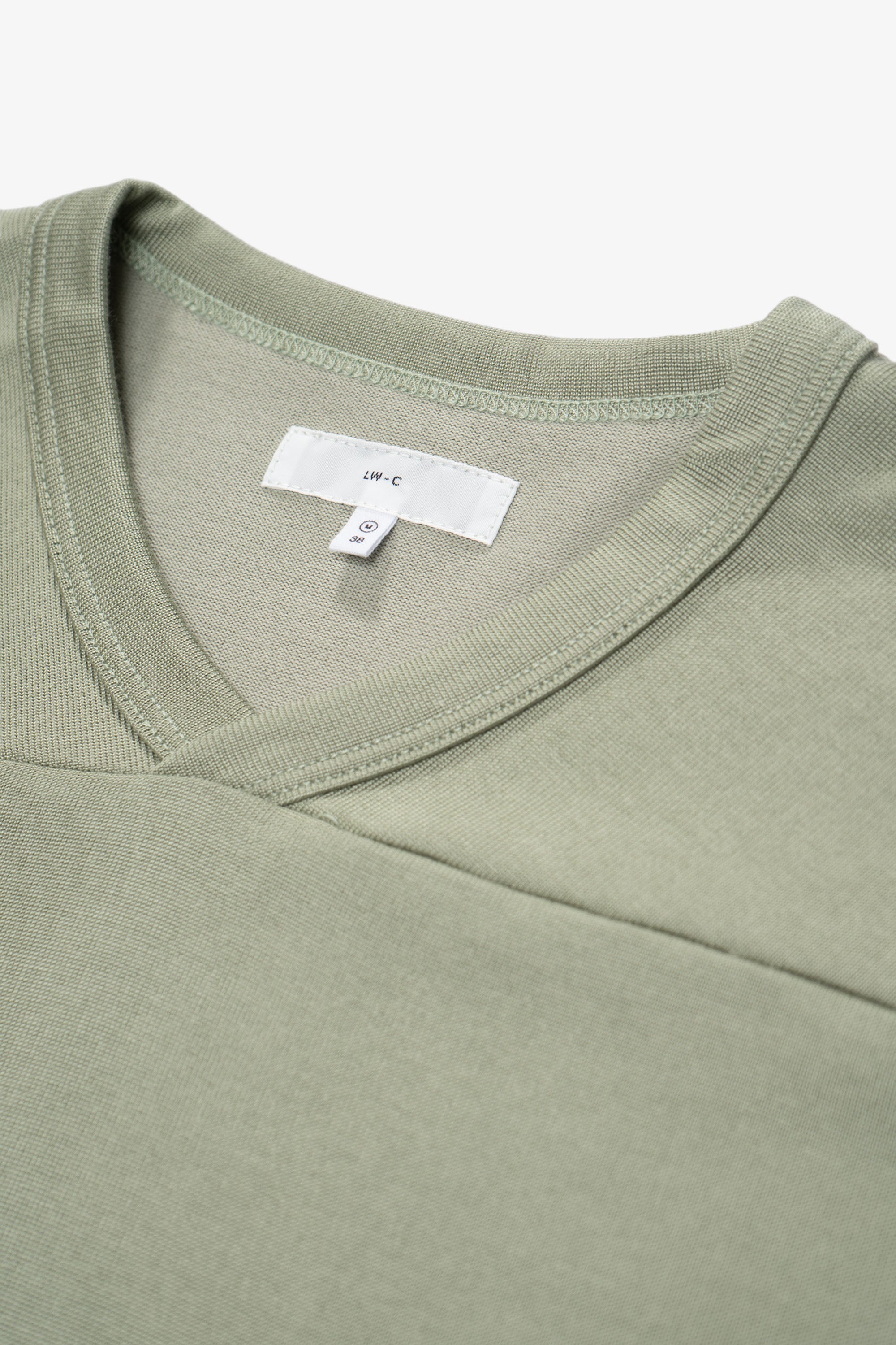 Collar detail of the LW135 LS Football T-shirt in a flat, pastel green, “Pistachio”